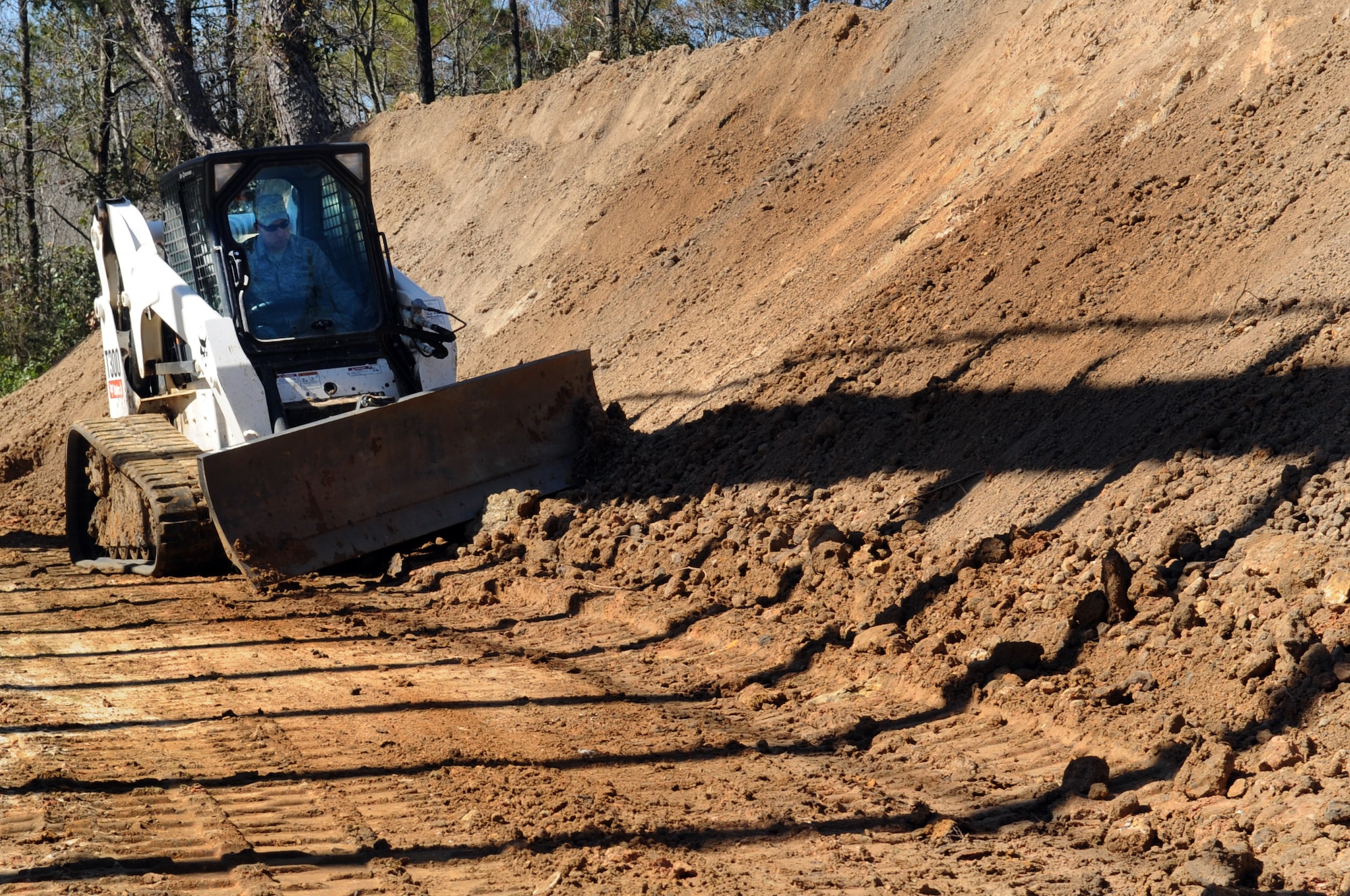 MOODY AIR FORCE BASE, Ga. -- Tech. Sgt. Joseph Ritter, 23rd Civil Engineer Squadron NCO in charge, creates a path using a bulldozer Feb. 14. The path was made to allow a dump truck to maneuver towards the construction being done at the Combat Arms Training and Maintenance range . (U.S. Air Force photo/Airman 1st Class Douglas Ellis)(RELEASED)
