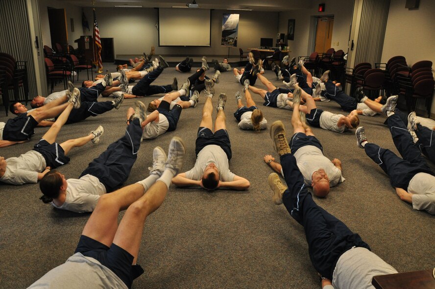 WRIGHT-PATTERSON AIR FORCE BASE, Ohio – Reservists from the 445th Aeromedical Evacuation Squadron perform butterfly kicks as part of their workout during routine physical training during the Feb. 12 unit training assembly. (U.S. Air Force photo/Tech. Sgt. Anthony Springer)