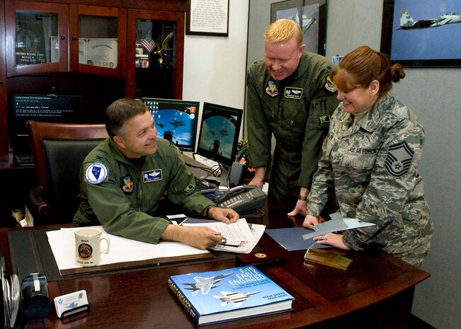 NELLIS AIR FORCE BASE, Nev. --  (left to right) Col. Terrence Fornof, Director of Requirements and Testing, U.S. Air Force Warfare Center, Lt. Col. Warren Rapp,commander, 232d Operations Squadron, and Senior Master Sgt. Victoriana Miller, commander support staff superintendent, review an official document Feb 8. Col. Fornof will take command of the Nevada Air National Guard on Feb. 12, 2011 in Reno. (U.S. Air Force photo by Airman 1st Class George Goslin)