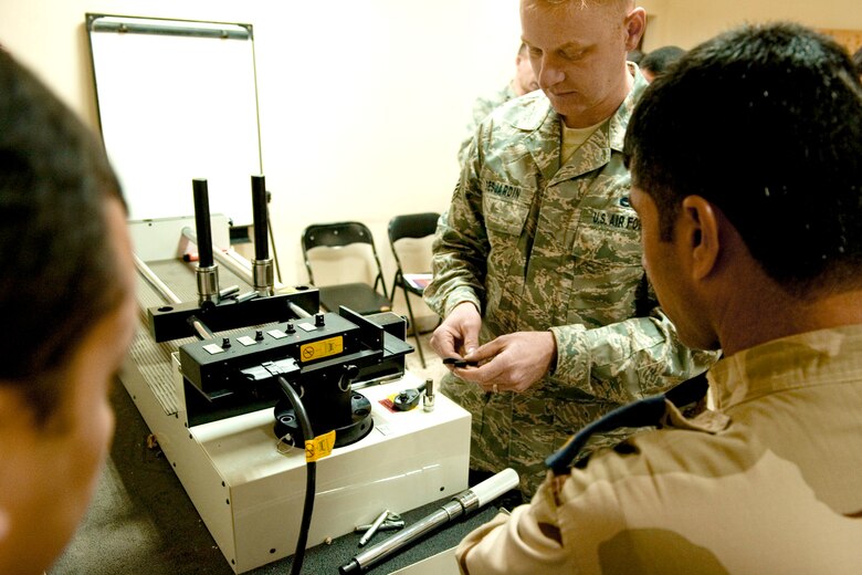 Master Sgt. Joel Desjardin trains Iraqi airmen on the proper calibration of torque wrenches Feb. 2, 2011, at New Al-Muthana Air Base, Iraq. Sergeant Desjardin is a member of the 4th Maintenance Group. He is part of a two-man team sent to train Iraqi airmen. (U.S. Air Force photo/Staff Sgt. Levi Riendeau)
