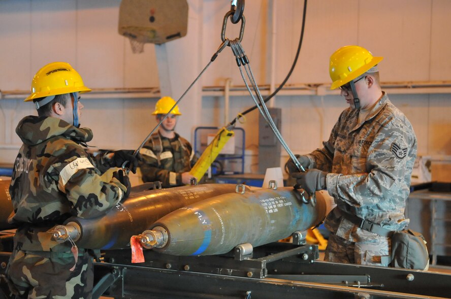 MINOT AIR FORCE BASE, N.D. -- Maintenance crew members from the 5th Munitions Squadron build unguided bombs at the conventional maintenance shop during a base exercise here Feb. 11. Conventional maintenance crew members are evaluated while assembling bombs to meet armor load standardizations to support the 23rd and 69th Bomb Squadrons. (U.S. Air Force photo/Airman 1st Class Jessica McConnell)