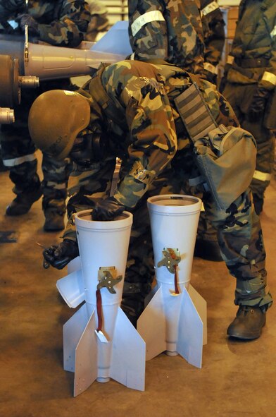 MINOT AIR FORCE BASE, N.D. – Staff Sgt. Derek Ferch, 5th Munitions Squadron maintenance crew member, helps assemble unguided bombs at the conventional maintenance shop here Feb. 11. Conventional maintenance crew members are evaluated while assembling bombs to meet armor load standardizations to support the 23rd and 69th Bomb Squadrons. (U.S. Air Force photo/Airman 1st Class Jessica McConnell)