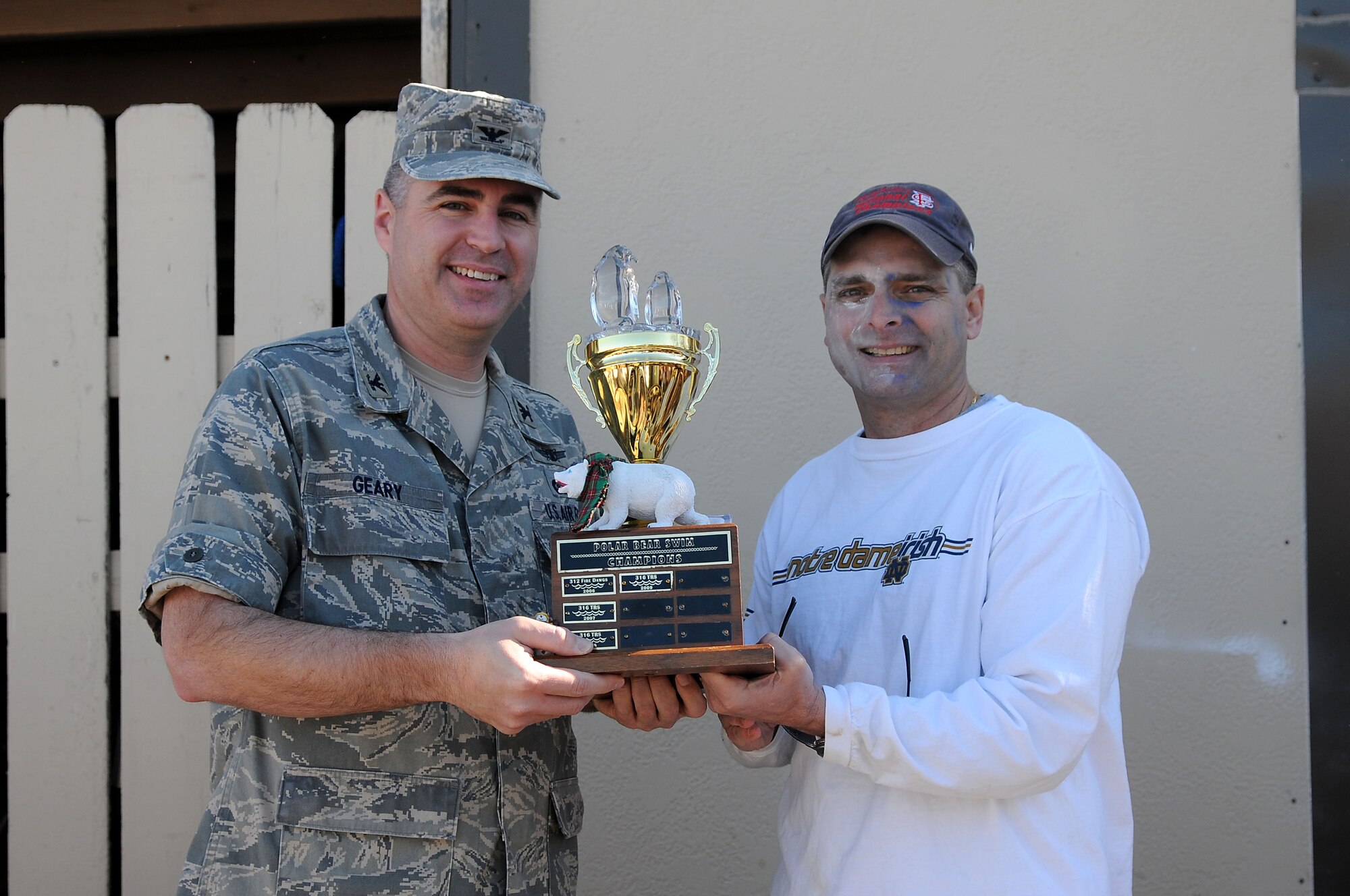 GOODFELLOW AIR FORCE BASE, Texas -- Col. Thomas Geary, Commander of the 17th Training Wing, presents a trophy to Lt. Col. Erik Lawson, Commander of the 316 Training Squadron, for highest percentage of unit participation in this year's Polar Bear Swim , Feb 12. Team Goodfellow members braved the cold waters of Lake Nasworthy during this year's Polar Bear Swim, at the Goodfellow Recreational Camp. (U.S. Air Force photo/Staff Sgt. Heather L Rodgers)
