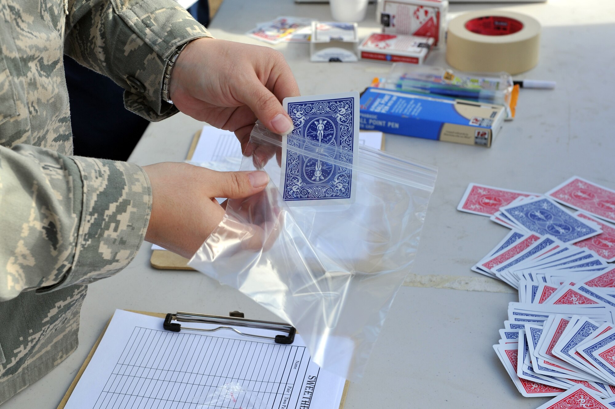 An Airman from the 19th Force Support Squadron fitness center holds a playing card from the deck used during the Sweetheart Poker 5-km run and walk Feb. 14, 2011, at Little Rock Air Force Base, Ark. The use of the cards was to increase the chances of participates winning a prize at the end of the run by drawing their card during the finish line raffle.  (U.S. Air Force photo by Staff Sgt. Chris Willis)