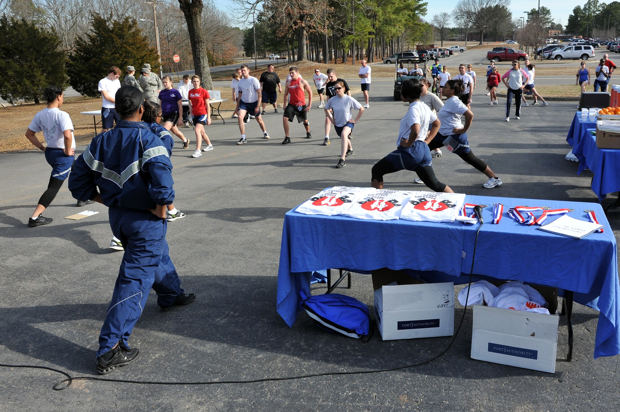 Airmen from the 19th Force Support Squadron fitness center perform a pre-run warm up with the participants of the Sweetheart Poker 5-km run and walk Feb. 14, 2011, at Little Rock Air Force Base, Ark. The fitness center has themed fun runs every month, which are free and open to everyone with access to the base.  (U.S. Air Force photo by Staff Sgt. Chris Willis)