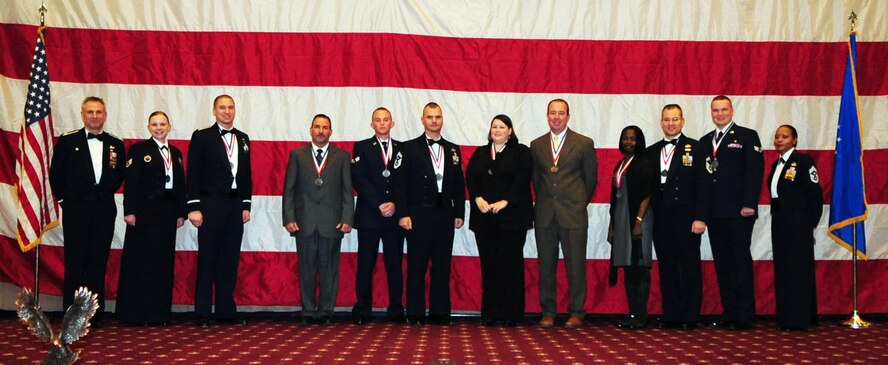 (Outside left) Col. Tim Fay, 2nd Bomb Wing commander and (outside right) Chief Master Sgt. Joe Ann Pace, 2 BW command chief, pose for a group photo with the 2 BW annual award winners; Staff Sgt. Kelley Kessler, Capt. Michael Pontius, Mr. Richard Knowles, Senior Airman Cory Shaw, Senior Master Sgt. Derrick Grames, Mrs. Rachel Penwell, Mr. William Duckworth, Ms. Terri Campbell, Senior Master Sgt. Todd Krulcik, and Senior Airman Marthinus Taljaard. The winners were announced during the 2 BW annual awards banquet held at Hoban Hall located on Barksdale Air Force Base, La., Feb. 11. (U.S. Air Force photo/Senior Airman Joanna M. Kresge)