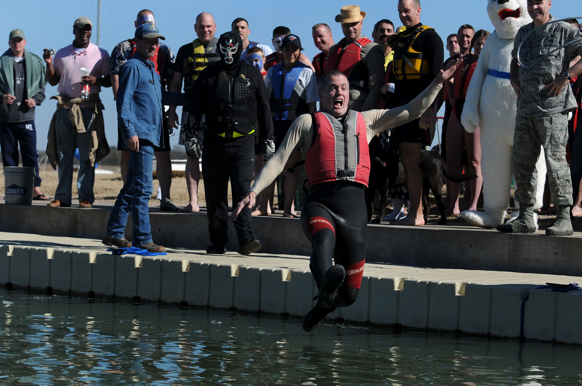 GOODFELLOW AIR FORCE BASE, Texas -- Col. J.D. Willis, Commander of the 17th Training Group, takes the leap into Lake Nasworthy at the Goodfellow Recreational Camp, Feb 12.  Col. Willis was the first to take the plunge at this year's Goodfellow Polar Bear Swim.  (U.S. Air Force photo/Staff Sgt. Heather L Rodgers) 