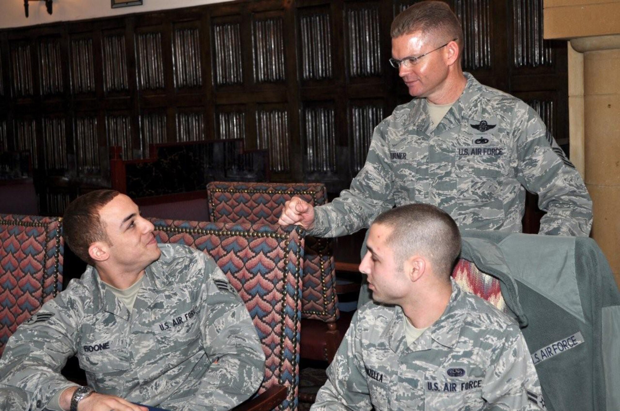 RAF MILDENHALL, England – Chief Master Sgt. William Turner (standing), Air Force Special Operations Command command chief, discusses tips to a happy marriage with Senior Airman William Boone, 352nd Special Operations Group, following lunch with 352nd SOG annual awards nominees, Jan. 28, 2011.  This was Chief Turner’s first visit to the 352nd SOG since his assignment as AFSOC command chief.  He ended his visit by attending the 352nd SOG annual awards ceremony where he was the guest speaker.  (U.S. Air Force photo/Tech. Sgt. Marelise Wood)