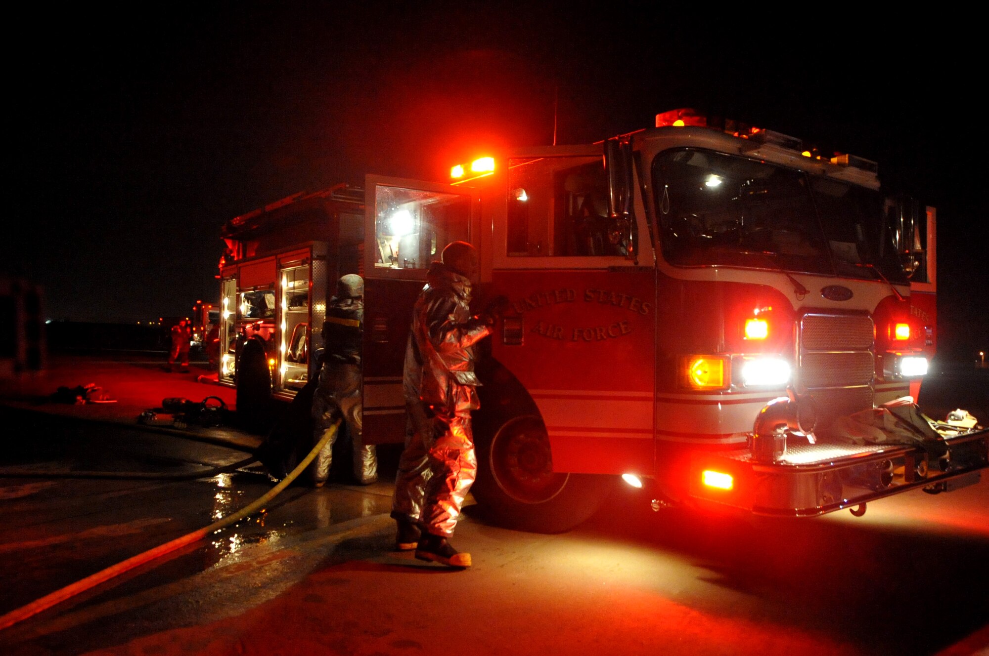 The 51st Civil Engineer Squadron firefighter department and 51st Medical Group respond to a simulated aircraft fire during Operational Readiness Exercise Beverly Midnight 11-01 at Osan Feb. 14. The exercise allows Airmen to demonstrate their ability to complete the mission in simulated chemical environments while executing their primary duties, practicing self aid and buddy care, conduction post-attack reconnaissance and unexploded ordnance sweeps (U.S. Air Force photos/Senior Airman Evelyn Chavez).