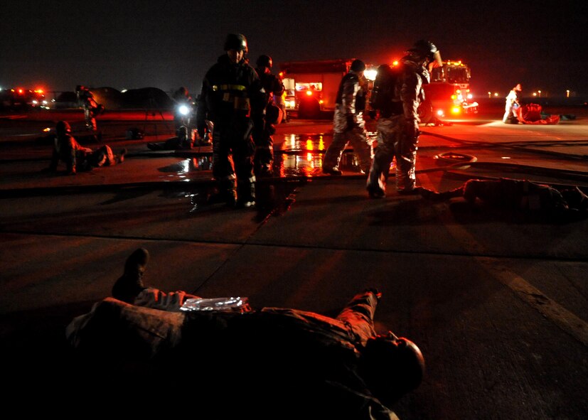 The 51st Civil Engineer Squadron firefighter department and 51st Medical Group respond to a simulated aircraft fire during Operational Readiness Exercise Beverly Midnight 11-01 at Osan Feb. 14. The exercise allows Airmen to demonstrate their ability to complete the mission in simulated chemical environments while executing their primary duties, practicing self aid and buddy care, conduction post-attack reconnaissance and unexploded ordnance sweeps (U.S. Air Force photos/Senior Airman Evelyn Chavez).