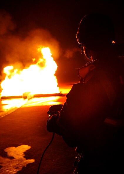 The 51st Civil Engineer Squadron firefighter department and 51st Medical Group respond to a simulated aircraft fire during Operational Readiness Exercise Beverly Midnight 11-01 at Osan Feb. 14. The exercise allows Airmen to demonstrate their ability to complete the mission in simulated chemical environments while executing their primary duties, practicing self aid and buddy care, conduction post-attack reconnaissance and unexploded ordnance sweeps (U.S. Air Force photos/Senior Airman Evelyn Chavez).
