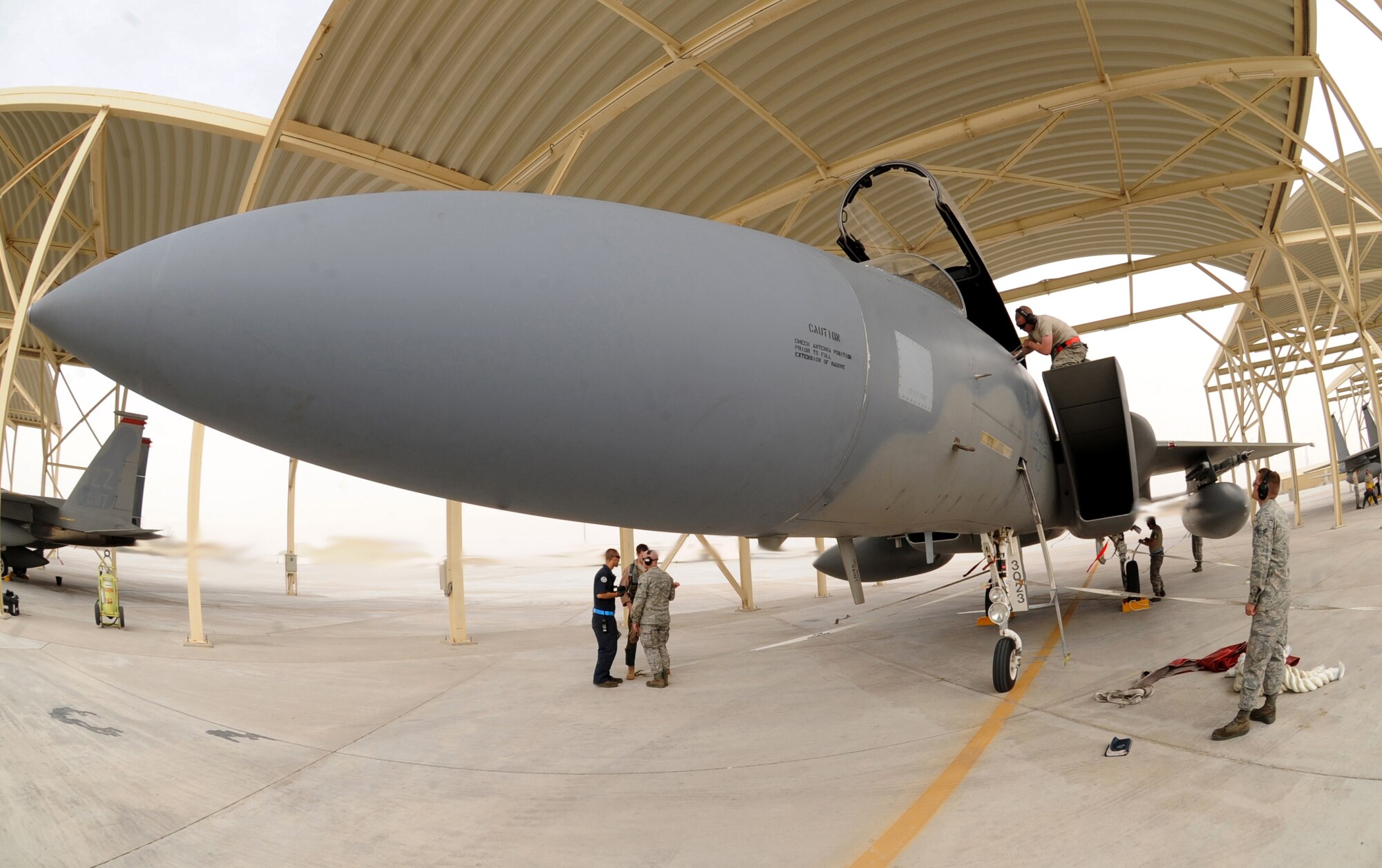 380th Expeditionary Aircraft Maintenance Squadron members run a basic post-flight inspection on an F-15C Eagle after arriving recently in Southwest Asia. The 67th Expeditionary Fighter Squadron currently flies the F-15C Eagle and is deployed from Kadena AFB, Japan. (U.S. Air Force photo illustration by Senior Airman Maynelinne De La Cruz)