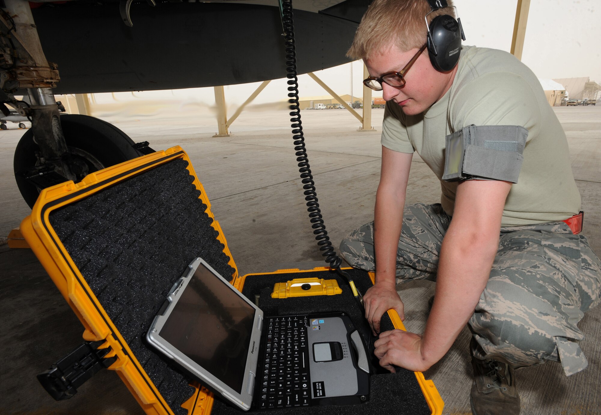 Airman 1st Class Daren Farber, 380th Expeditionary Aircraft Maintenance Squadron, performs the maintenance post-flight data down on an F-15C Eagle recently in Southwest Asia. The 67th Expeditionary Fighter Squadron currently flies the F-15C Eagle and is deployed from Kadena AFB, Japan. (U.S. Air Force photo illustration by Senior Airman Maynelinne De La Cruz)