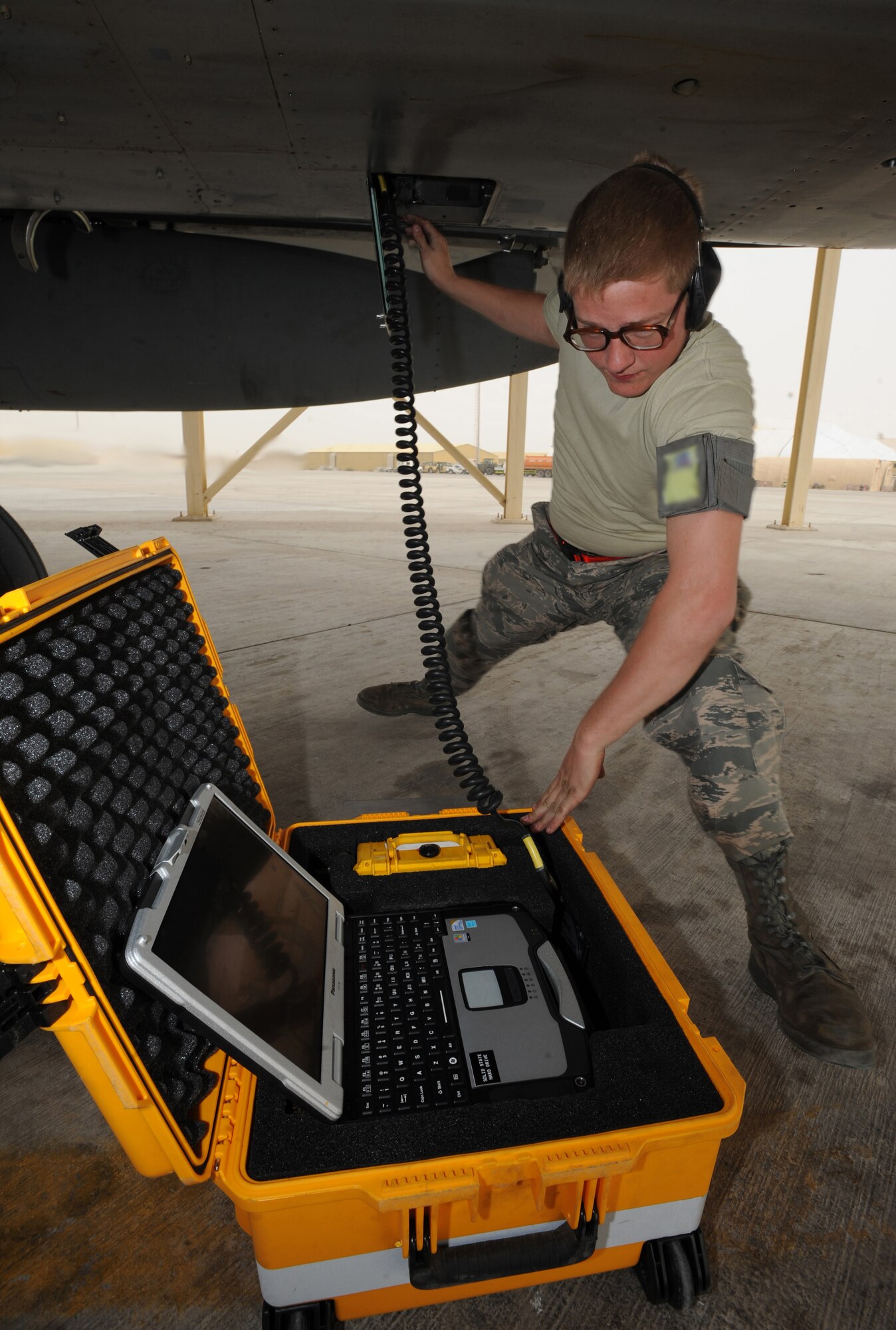 Airman 1st Class Daren Farber, 380th Expeditionary Aircraft Maintenance Squadron, performs the maintenance post-flight data down on an F-15C Eagle recently in Southwest Asia. The 67th Expeditionary Fighter Squadron currently flies the F-15C Eagle and is deployed from Kadena AFB, Japan. (U.S. Air Force photo illustration by Senior Airman Maynelinne De La Cruz)