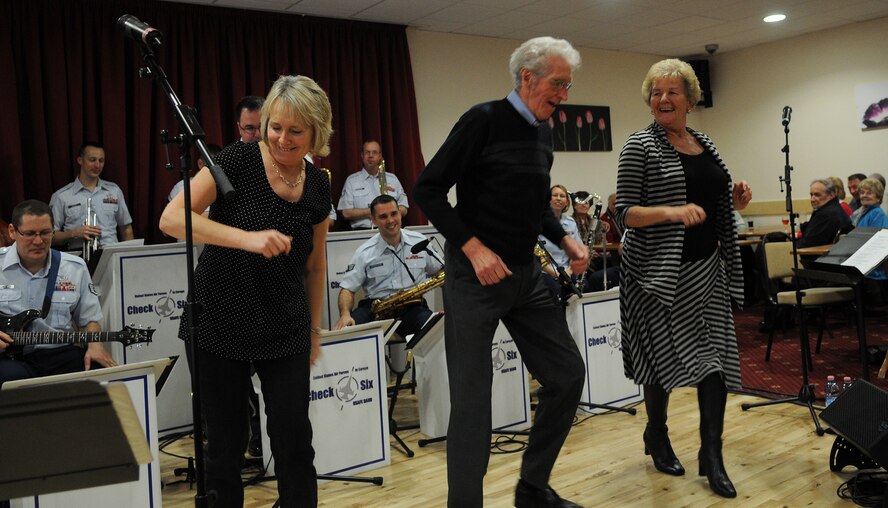 MILDENHALL, England -- Carol and Tom Ashdown and Margaret Clayton, local residents, dance on stage during a performance by the U.S. Air Forces in Europe Band Check Six ensemble at the Mildenhall Social Club Feb. 13, 2011. The free concert attracted a crowd that nearly filled the facility to capacity. (U.S. Air Force photo/Staff Sgt. Thomas Trower)