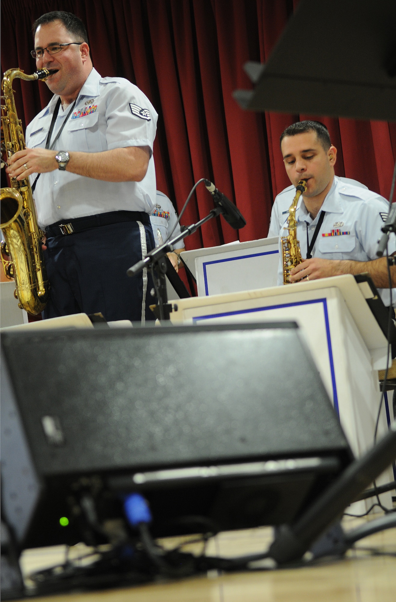 MILDENHALL, England -- Staff Sgt. David Fatek and Senior Airman Lencys Esteban Nunez, U.S. Air Forces in Europe Band play the saxophone in a performance at the Mildenhall Social Club Feb. 13, 2011. The 13-piece ensemble, dubbed Check Six, gave the free concert to local residents as a way to build partnerships and community relations. (U.S. Air Force photo/Staff Sgt. Thomas Trower)