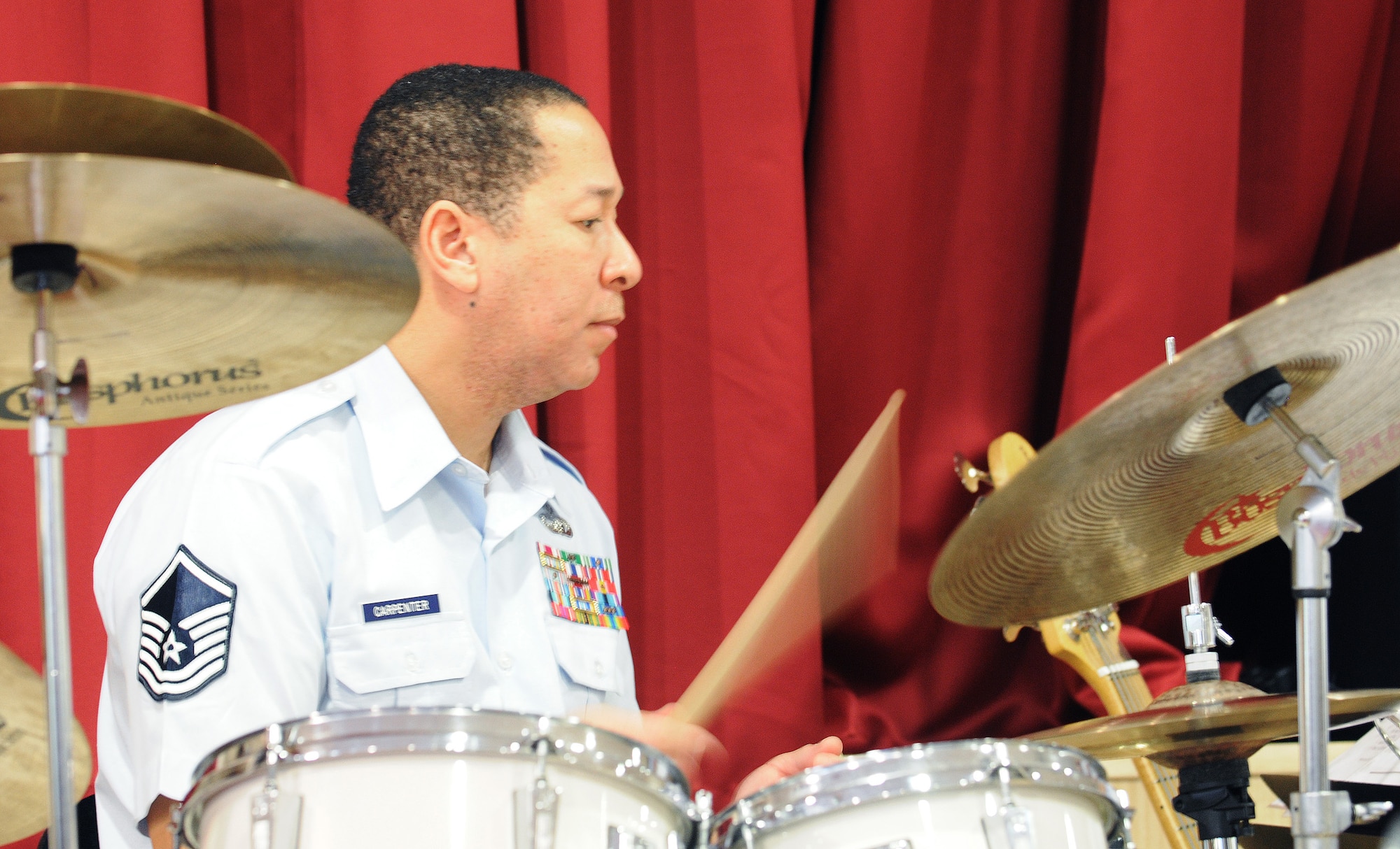 MILDENHALL, England -- Master Sgt. Anthony Carpenter, U.S. Air Forces in Europe Band Check Six ensemble, performs a drum solo at the Mildenhall Social Club Feb. 13, 2011. The band, from Sembach Air Base, Germany, played a free concert as a way of continually building partnerships and community relations with local residents. (U.S. Air Force photo/Staff Sgt. Thomas Trower)