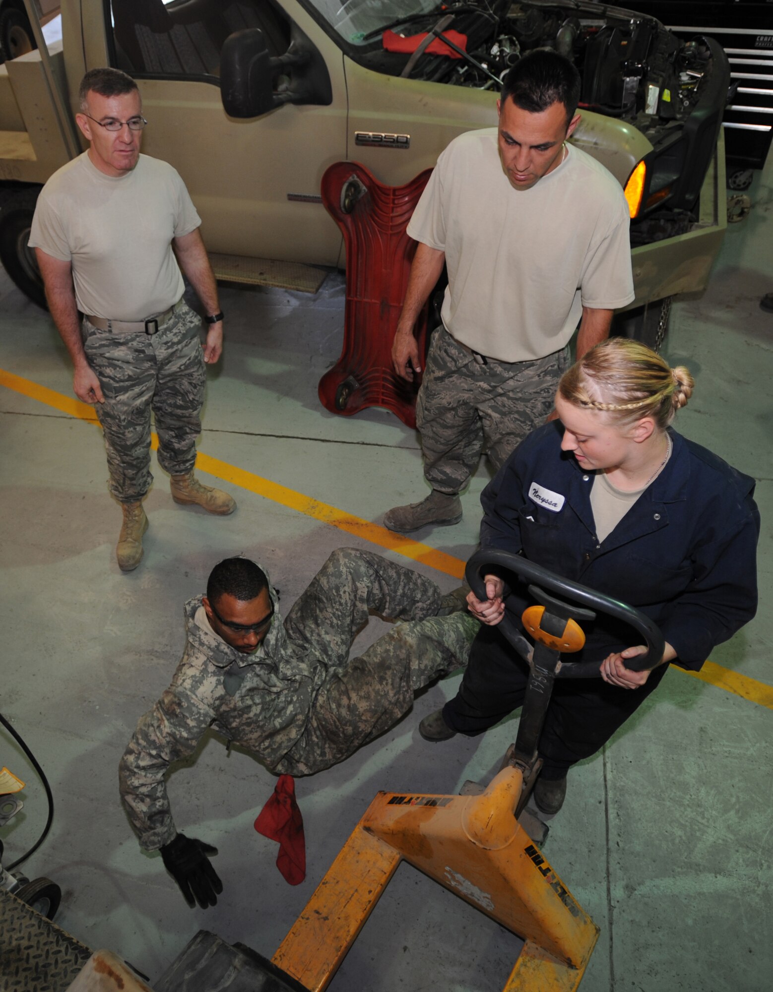 (clockwise from top left) Master Sgt. George Lloyd and Staff Sgt. Issai Arias observe Staff Sgt. Neryssa Adrian and Senior Airman Brandon Dorsey as they team up to work on a forklift at the 380th Expeditionary Logistics Readiness Squadron located at an undisclosed location in Southwest Asia. The shop generally services around three to five vehicles each day. MSgt Lloyd is deployed from the 6th LRS, MacDill AFB, Fla. SSgt. Arias is deployed from 436th LRS, Dover AFB, Del. SSgt. Adrian is deployed here from the 133rd LRS, Minnesota Air National Guard. Airman Dorsey is an Air National Guardsman deployed from the 138th LRS, Tulsa AFB, Okla. (U.S. Air Force photo by Senior Airman Maynelinne De La Cruz)