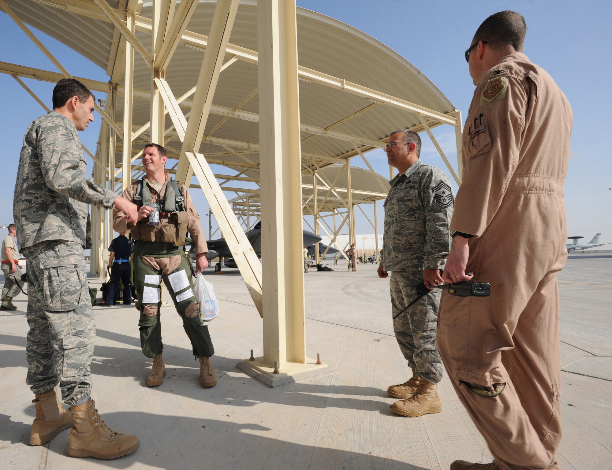 Brig. Gen. Mike Minahan, 380th Air Expeditionary Wing commander, greets 67th Expeditionary Fighter Squadron pilots as they arrived in Southwest Asia recently. The 67th EFS currently flies the F-15C Eagle and is deployed from Kadena AFB, Japan. (U.S. Air Force photo by Maynelinne De La Cruz)
