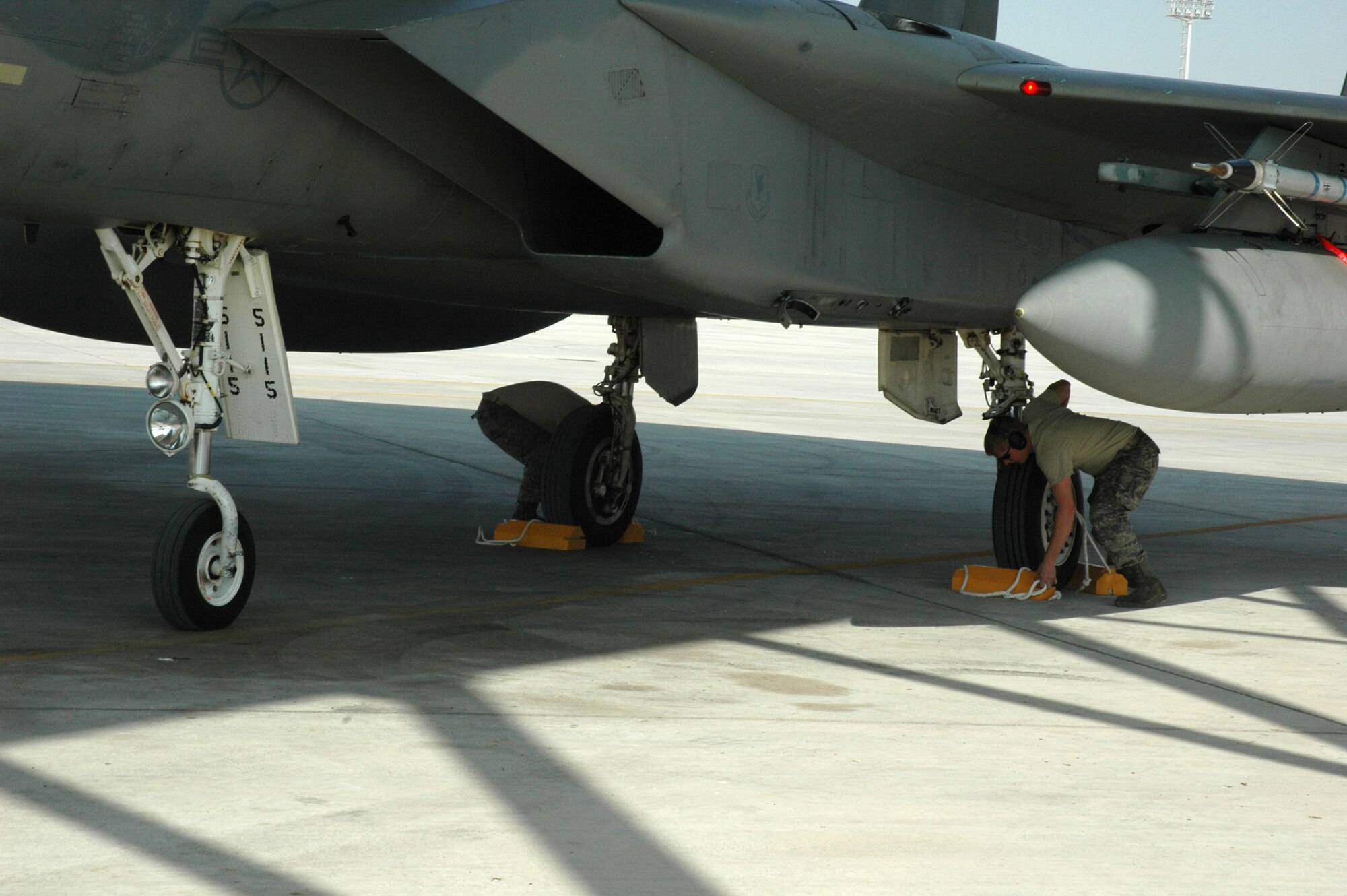 Maintainers from the 380th Expeditionary Aircraft Maintenance Squadron place chalks on the 67th Expeditionary Fighter Squadron F-15Cs wheels shortly after they arrived in Southwest Asia. The 67th EFS is deployed from Kadena AFB, Japan. (U.S. Air Force photo by Master Sgt. Julie Briden-Garcia)
