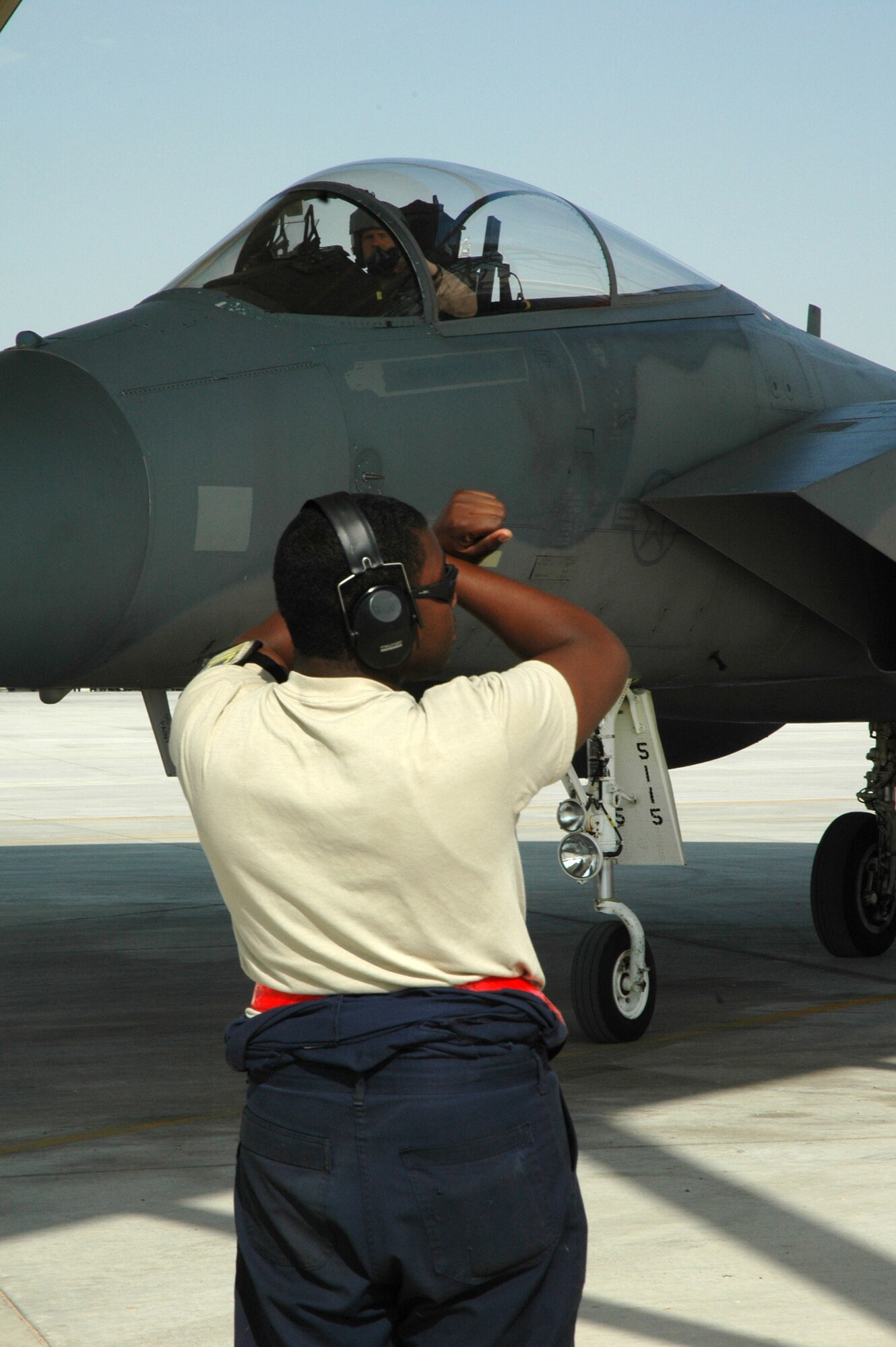 Maintainers from the 380th Expeditionary Aircraft Maintenance Squadron marshal in the 67th Expeditionary Fighter Squadron F-15Cs as they arrived in Southwest Asia recently. The 67th EFS is deployed from of Kadena AFB, Japan. (U.S. Air Force photo by Master Sgt. Julie Briden-Garcia)