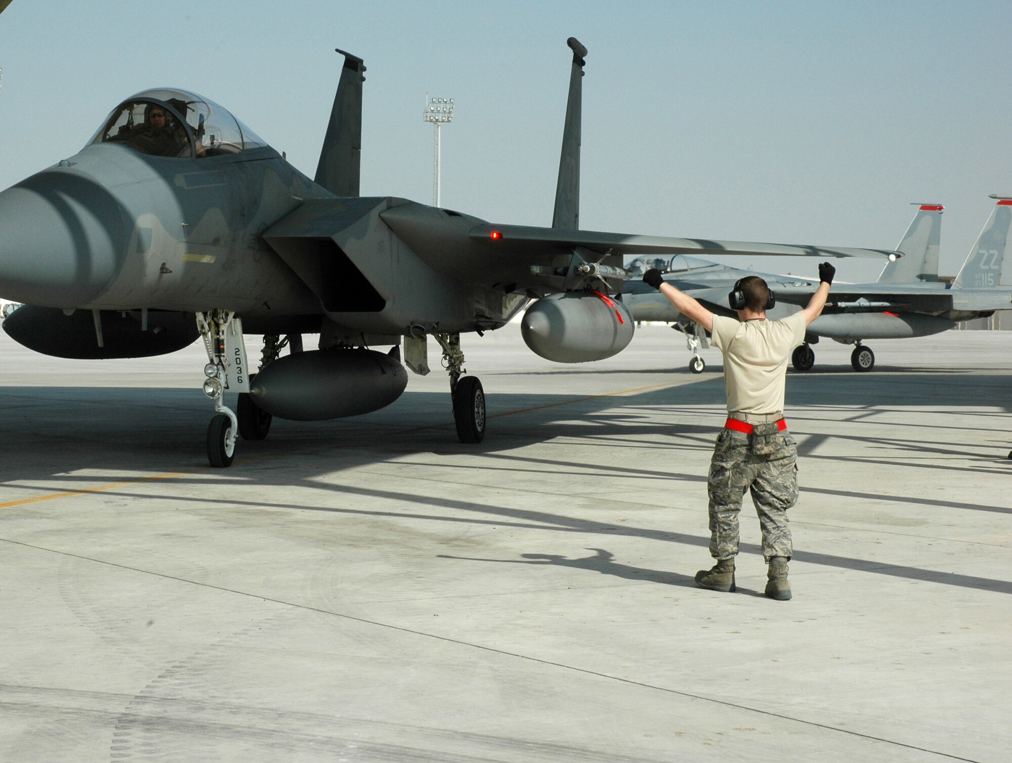 Maintainers from the 380th Expeditionary Aircraft Maintenance Squadron marshal in the 67th Expeditionary Fighter Squadron F-15Cs as they arrived in Southwest Asia recently. The 67th EFS is deployed from Kadena AFB, Japan. (U.S. Air Force photo by Master Sgt. Julie Briden-Garcia)