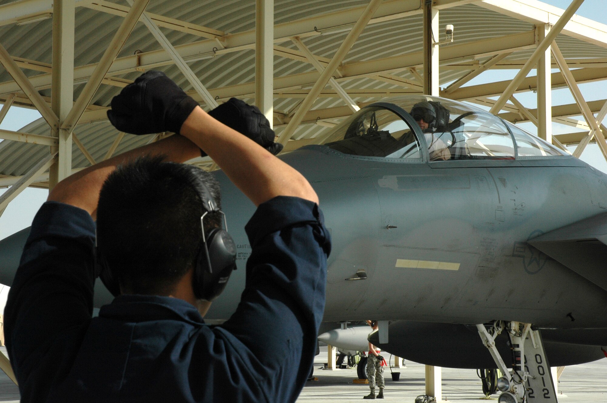 Maintainers from the 380th Expeditionary Aircraft Maintenance Squadron marshal in the 67th Expeditionary Fighter Squadron F-15Cs as they arrived in Southwest Asia recently. The 67th EFS is deployed from Kadena AFB, Japan. (U.S. Air Force photo by Master Sgt. Julie Briden-Garcia)