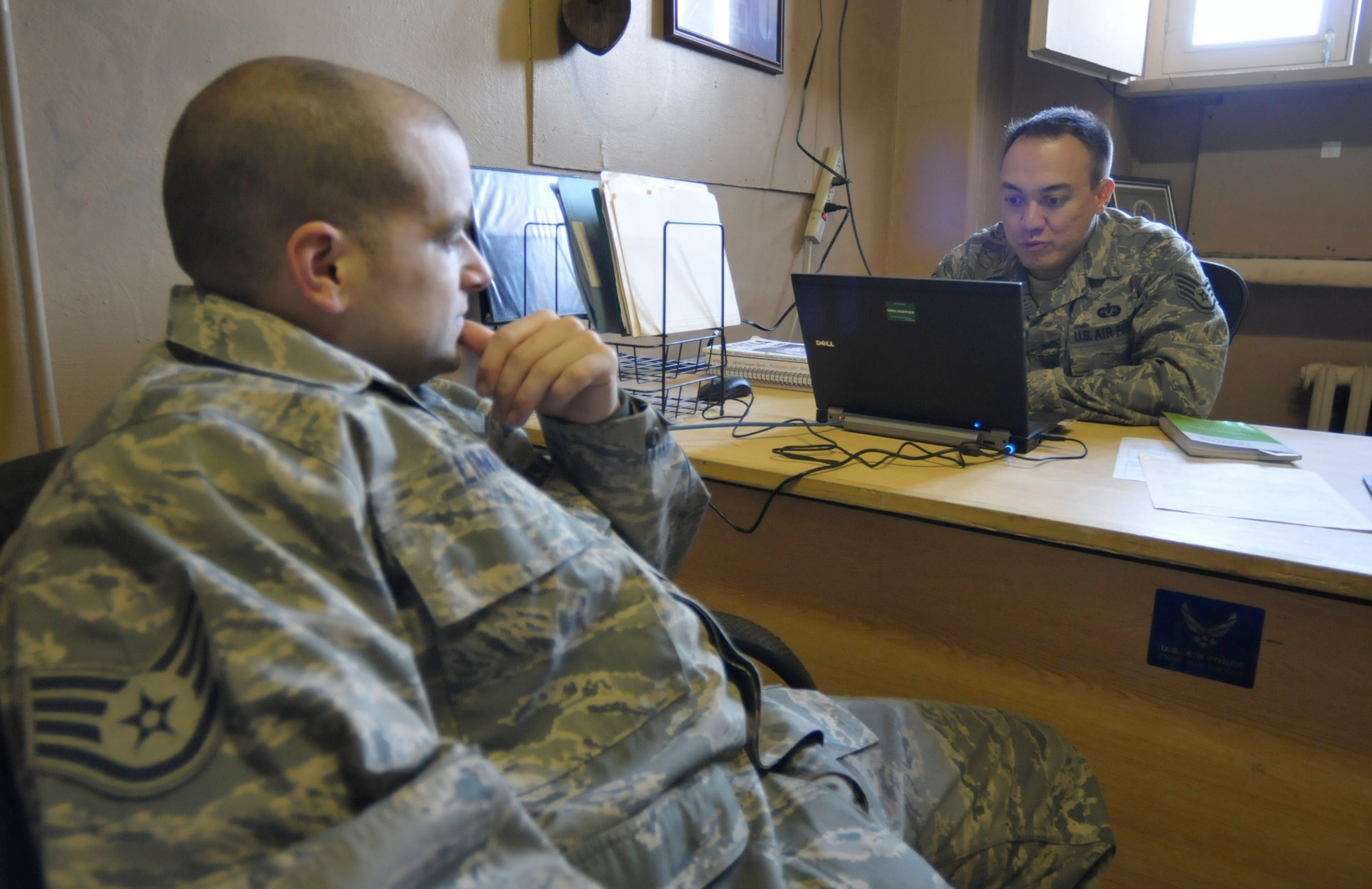 Staff Sgt. Benjamin Yost, 455th Air Expeditionary Wing paralegal assist Staff Sgt. Jonathan Lima an F-16, Fighting Falcon, crewchief prepare his state-tax return at Bagram Airfield, Afghanistan, 15 Feb. 2011. The legal office here is offering deployed servicemembers assistance with taxes by providing volunteer income tax assistance representatives. (Air Force photo by Tech. Sgt. Michael Voss)