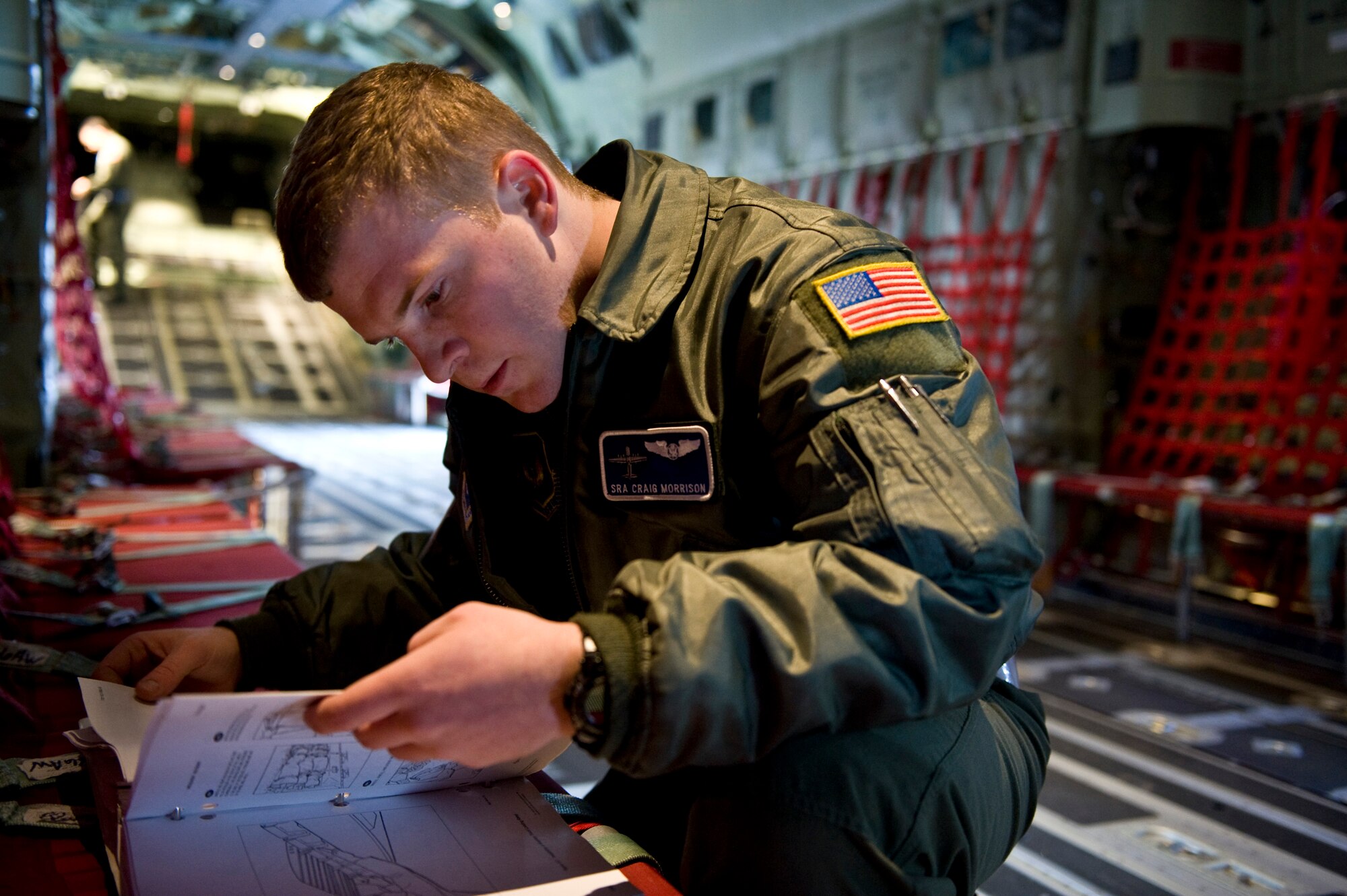 U.S. Air Force Senior Airman Craig Morrison, 37th Airlift Squadron, reviews the aircraft checklist of a C-130J Hercules, from Ramstein Air Base, Germany in preparation for an airdrop mission over the Marnheim, Germany drop zone, Feb. 10, 2011. The single C-130J aircraft from the 37th Airlift Squadron, 86th Airlift Wing dropped more than fifty service members at the drop site.  (U.S. Air Force photo/TSgt Wayne Clark, AFNE Regional News Bureau) (Released)