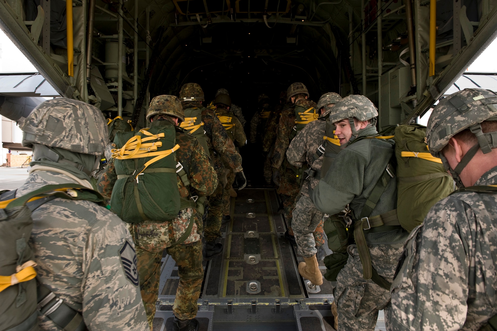 U.S. Army Soldiers, Air Force Airmen and German soldiers load into a C-130J Hercules, from Ramstein Air Base, Germany, in preparation for a training airdrop over drop zone Marnheim, Germany, Feb. 10, 2011. The single C-130J aircraft from the 37th Airlift Squadron, 86th Airlift Wing dropped more than fifty service members at the drop site.  (U.S. Air Force photo/TSgt Wayne Clark, AFNE Regional News Bureau) (Released)