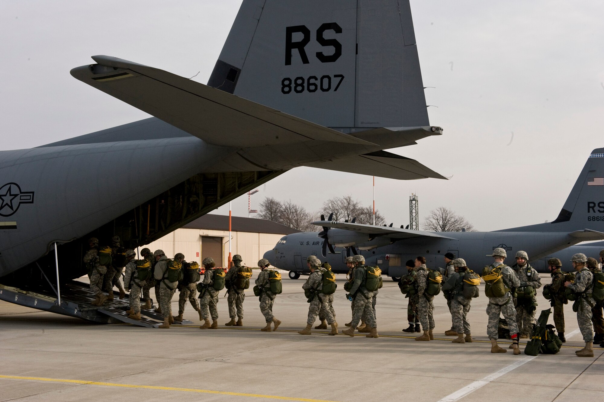 U.S. Army Soldiers, Air Force Airmen and German soldiers load into a C-130J Hercules, from Ramstein Air Base, Germany, in preparation for a training airdrop over drop zone Marnheim, Germany, Feb. 10, 2011. The single C-130J aircraft from the 37th Airlift Squadron, 86th Airlift Wing dropped more than fifty service members at the drop site.  (U.S. Air Force photo/TSgt Wayne Clark, AFNE Regional News Bureau) (Released)