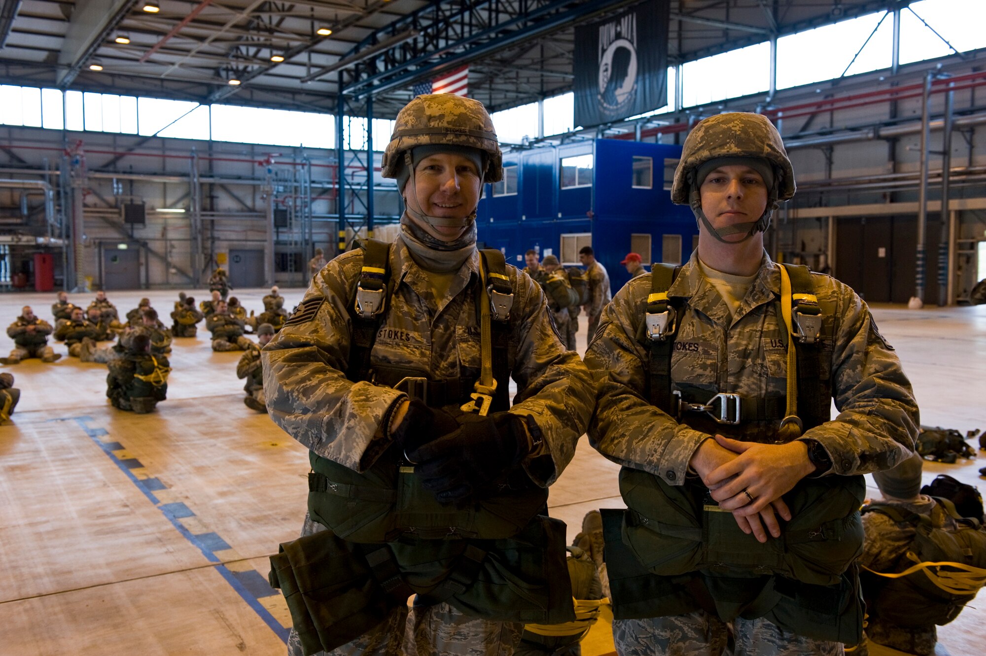 U.S. Air Force Technical Sergeant Raymond Stokes (left) and Staff Sergeant Jesse Stokes, both engineers with the 435th Security Forces Squadron and first cousins, pose for a photo before loading onto a C-130J Hercules, from Ramstein Air Base, Germany, in preparation for a training airdrop over drop zone Marnheim, Germany, Feb. 10, 2011. The single C-130J aircraft from the 37th Airlift Squadron, 86th Airlift Wing dropped more than fifty service members at the drop site.  (U.S. Air Force photo/TSgt Wayne Clark, AFNE Regional News Bureau) (Released)