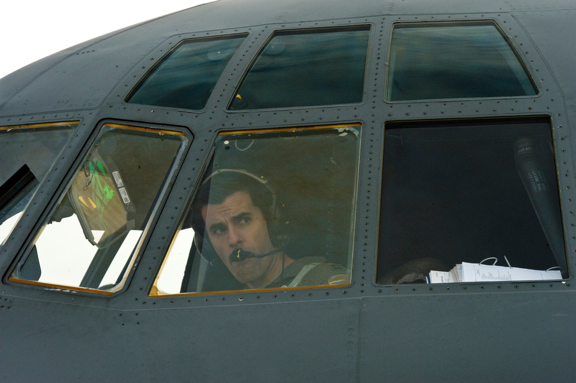 U.S. Air Force Capt. Timothy Fritz, 37th Airlift Squadron, looks out the window of a C-130J Hercules at Ramstein Air Base, Germany, in preparation for take off during a training airdrop mission at the Marnheim, Germany drop zone, Feb. 10, 2011. The single C-130J aircraft from the 37th Airlift Squadron, 86th Airlift Wing will drop more than fifty service members at the drop site.  (U.S. Air Force photo/TSgt Wayne Clark, AFNE Regional News Bureau) (Released)