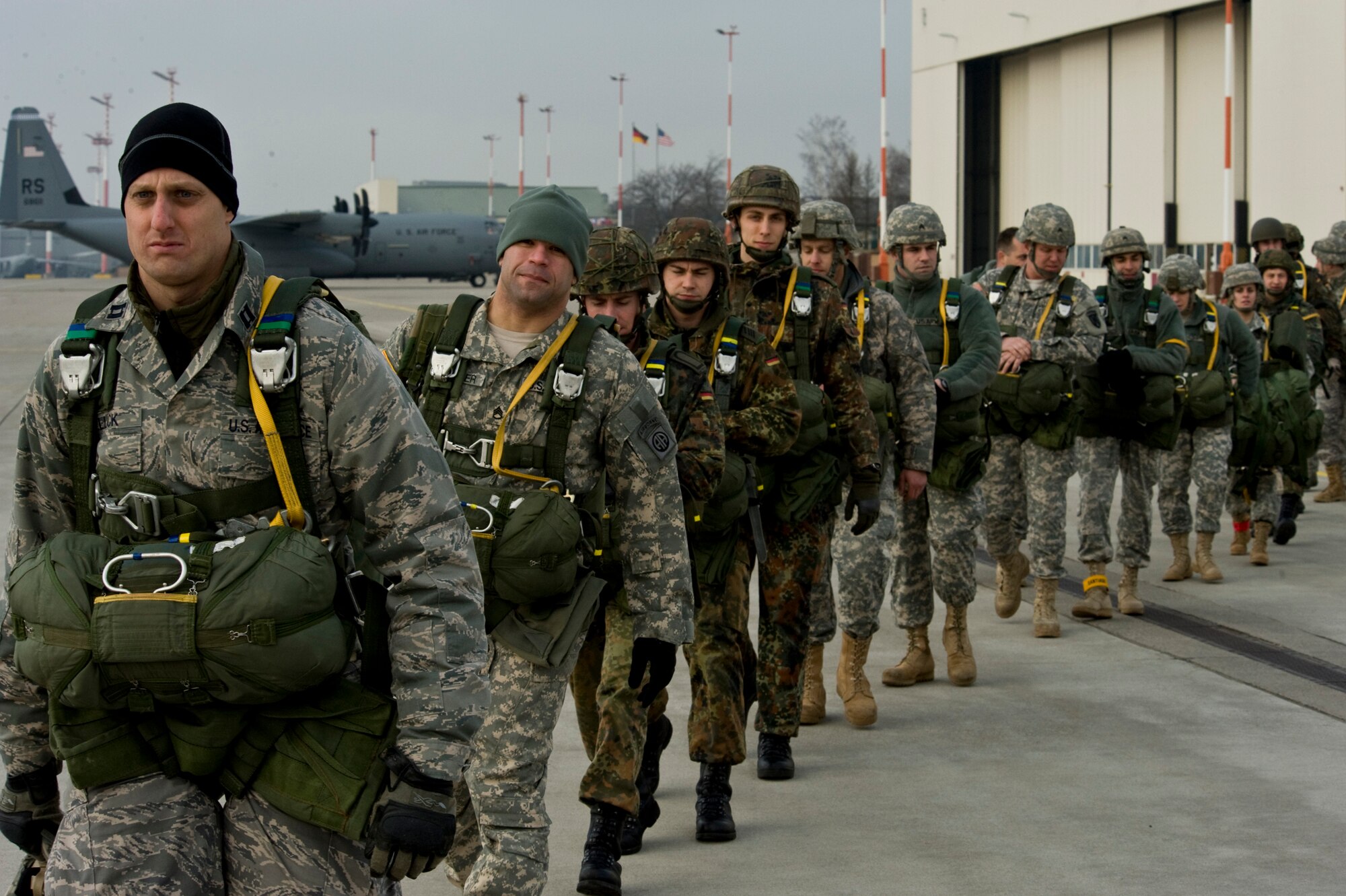 U.S. Army Soldiers, Air Force Airmen and German soldiers load into a C-130J Hercules, from Ramstein Air Base, Germany, in preparation for a training airdrop mission at the Marnheim, Germany drop zone, Feb. 10, 2011. The single C-130J aircraft from the 37th Airlift Squadron, 86th Airlift Wing will drop more than fifty service members at the drop site.  (U.S. Air Force photo/TSgt Wayne Clark, AFNE Regional News Bureau) (Released)