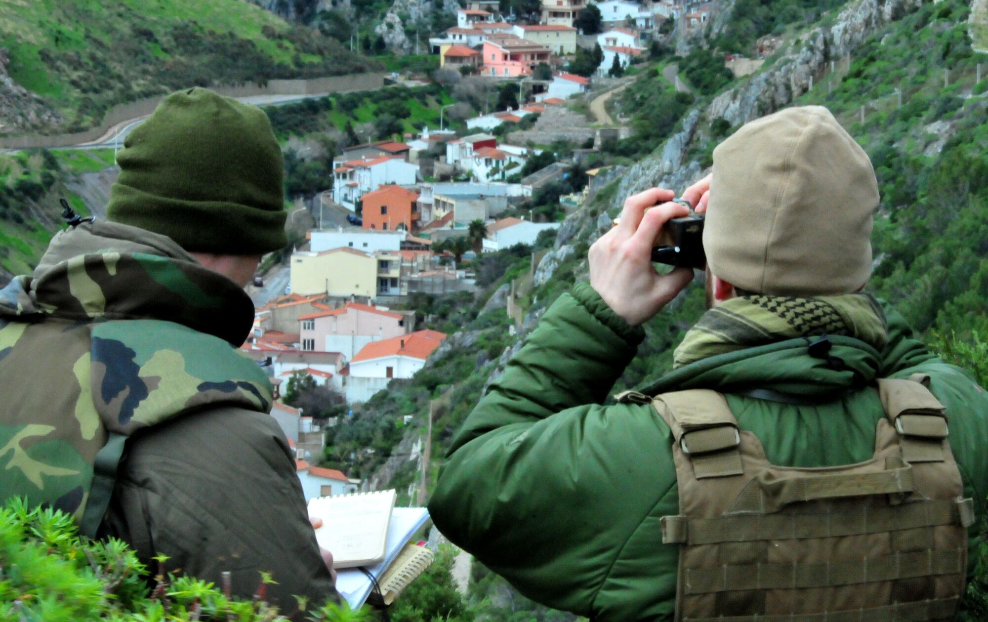 DECIMOMANNU AIR BASE, Italy -- Joint terminal attack controller students surveys a small village for signs of enemy activity during the JTAC qualification course field training in Sardinia, Italy, Feb. 1. Students from the U.S. Air Forces in Europe Air Ground Operations School in Einsiedlerhof Air Station, Germany, honed their skills with help from the 494th Fighter Squadron during the two-week exercise. During the training, F-15E Strike Eagles supported the students with close air support against simulated hostile targets. (U.S. Air Force photo / Staff Sgt. Megan P. Lyon)