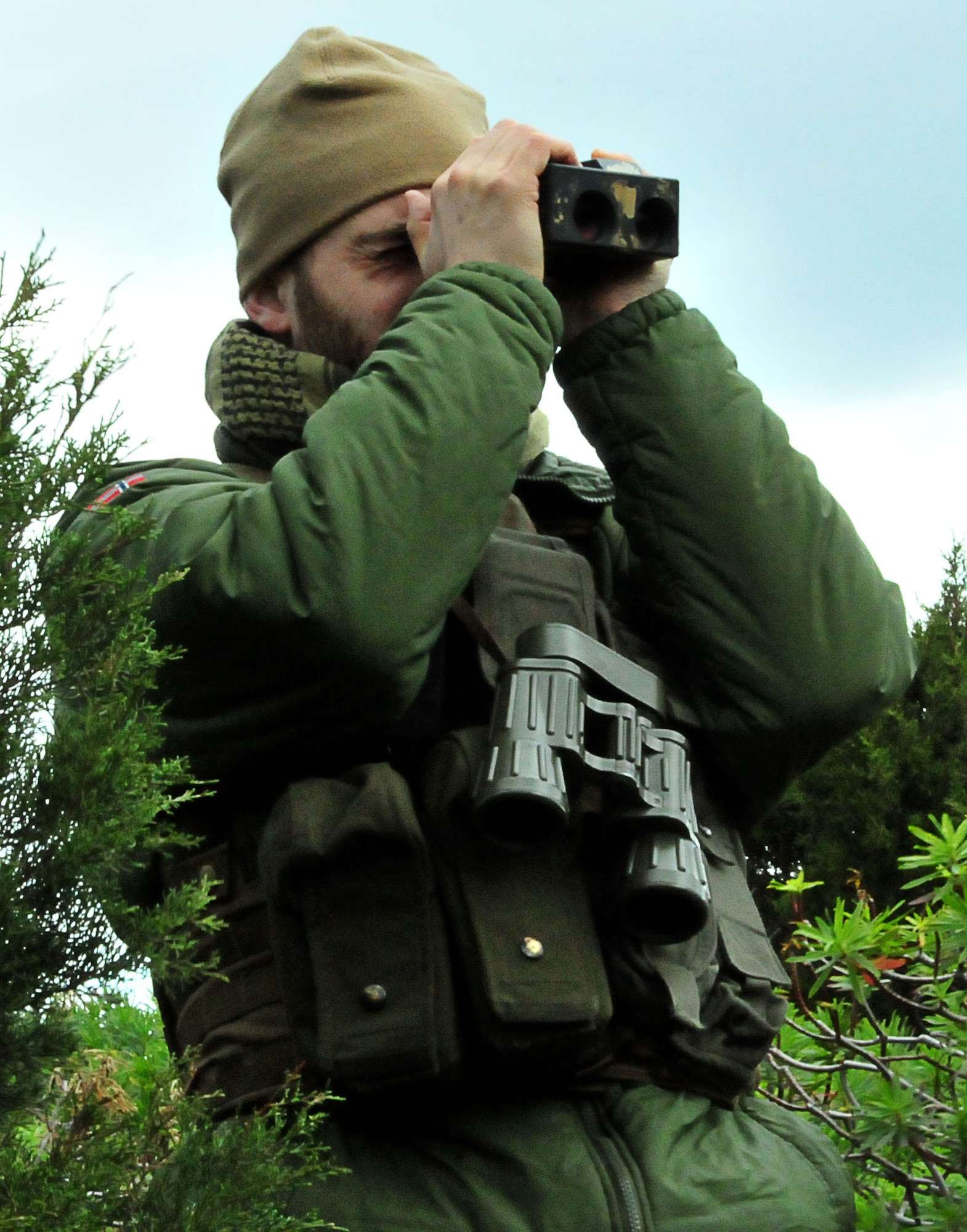 DECIMOMANNU AIR BASE, Italy -- A Norwegian joint terminal attack controller student surveys the area for signs of enemy activity during JTAC qualification course field training in Sardinia, Italy, Feb. 1. Students from the U.S. Air Forces in Europe Air Ground Operations School in Einsiedlerhof Air Station, Germany, honed their skills with help from the 494th Fighter Squadron during the two-week exercise. During the training, F-15E Strike Eagles supported the students with close air support against simulated hostile targets. (U.S. Air Force photo / Staff Sgt. Megan P. Lyon)