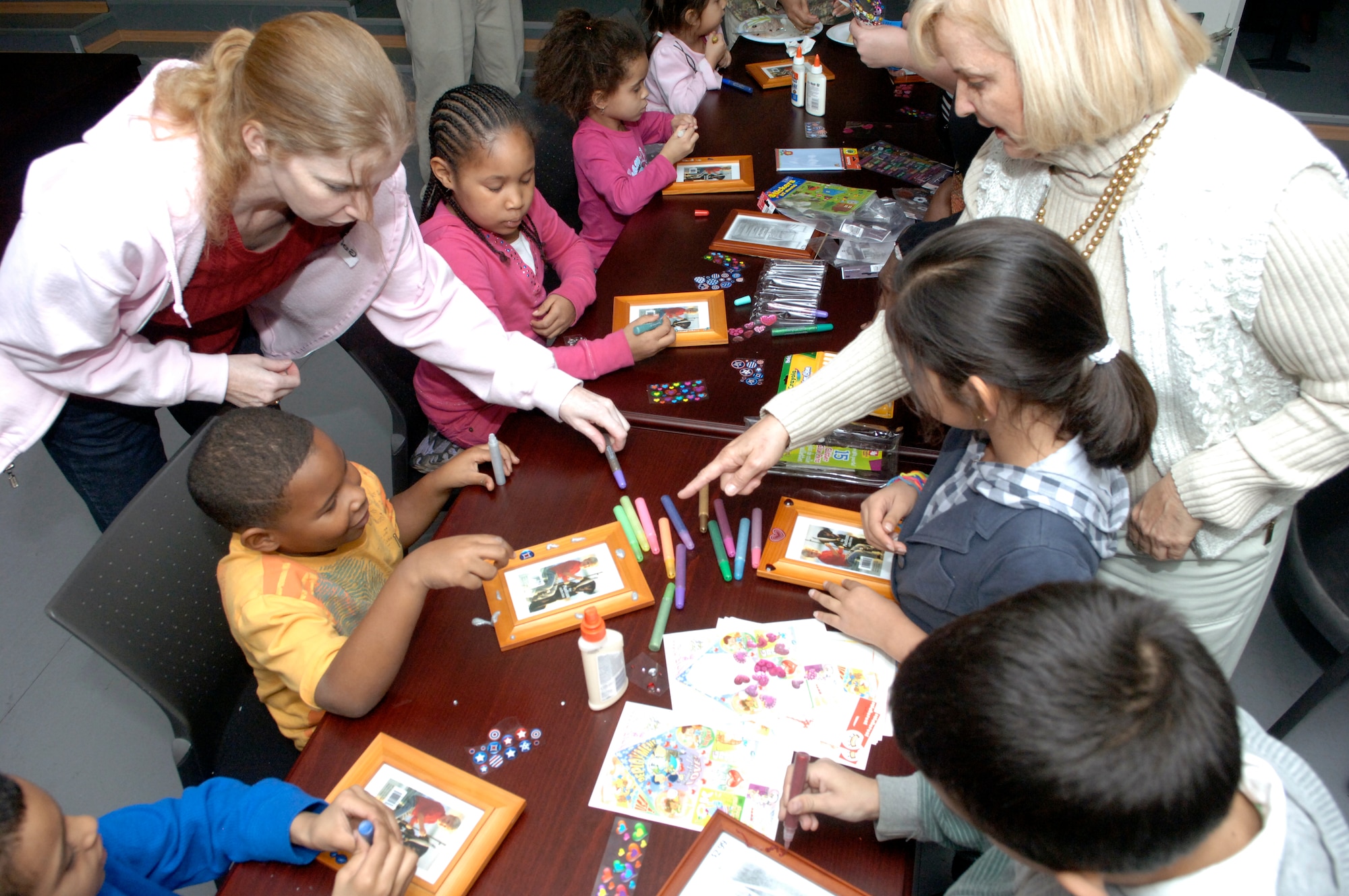 Children of deployed personnel participate in arts and crafts activities during the Hearts Apart dinner held Feb. 11, 2011, at the Airman and Family Readiness Center on Incirlik Air Base, Turkey. The children decorated picture frames, which will be sent to their deployed parents.  (U.S. Air Force photo by Senior Airman Anthony J. Hyatt/Released)