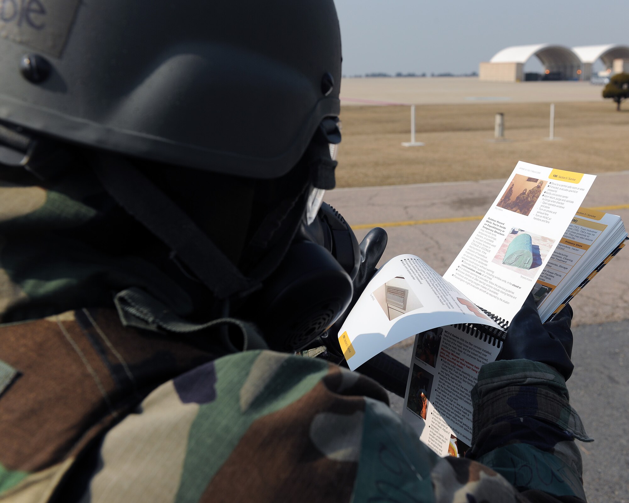 KUNSAN AIR BASE, Republic of Korea -- Senior Airman Tanielle Preble, 8th Operations Support Squadron, checks her Airman’s Manual for correct cordon procedures after discovery of an unexploded ordnance during exercise Beverly Midnight 11-1, Feb. 15, 2011. UXO’s must be cordoned immediately to minimize damage to personnel and assets. (U.S. Air Force photo/Senior Airman Ciara Wymbs) 