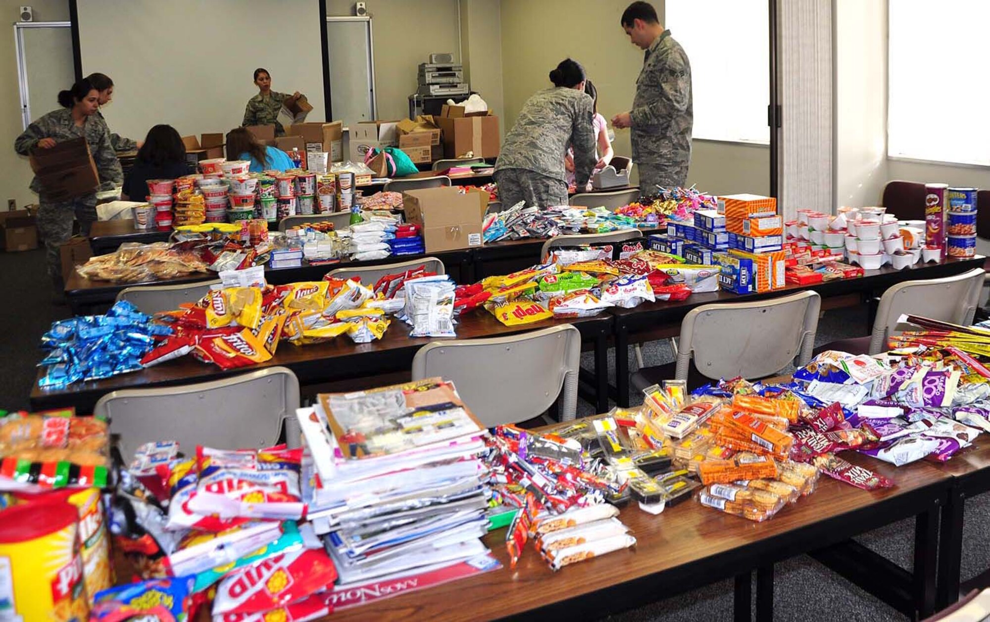 YOKOTA AIR BASE, Japan -- Members from the 374th Logistics Readiness Squadron and the Key Spouse committee set up items that will be put in care packages and sent to deployed Airmen from the squadron here Feb. 8. (Courtesy photo)