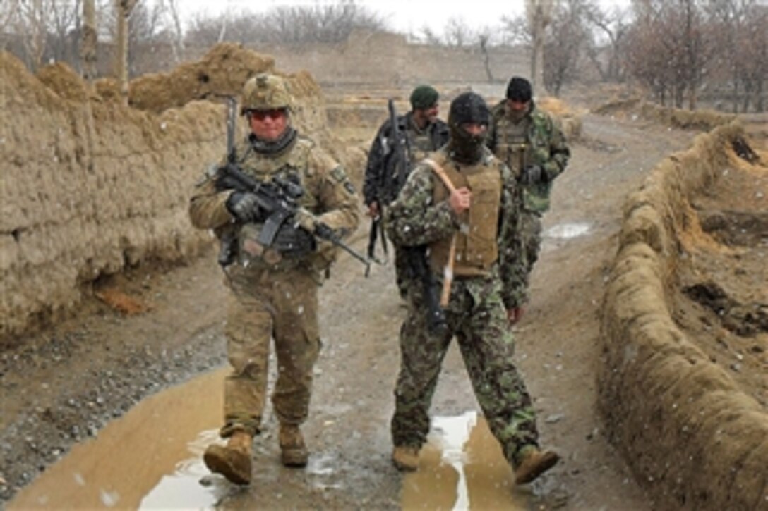U.S. Army Staff Sgt. Clint Koerperich (left) patrols with Afghan soldiers to investigate possible insurgent cache locations in the Zormat district of Afghanistan on Feb. 5, 2011.  Koerperich is assigned to Company C, 1st Battalion, 168th Infantry Regiment.  The soldiers acted on a tip provided by the Guardians of Peace program, which rewards Afghan citizens who provide useful and actionable intelligence to Afghan and coalition forces.  