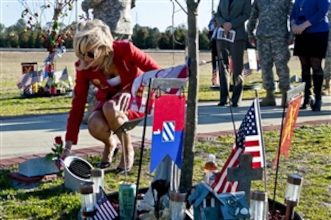 Dr. Jill Biden, wife of Vice President Joe Biden, lays a rose at the base of a tree along the Warriors Walk on Fort Stewart, Ga., Feb. 14, 2011. The Warriors Walk serves as a monument to 3rd Infantry Division soldiers who were killed in combat during operations Iraqi Freedom and Enduring Freedom.