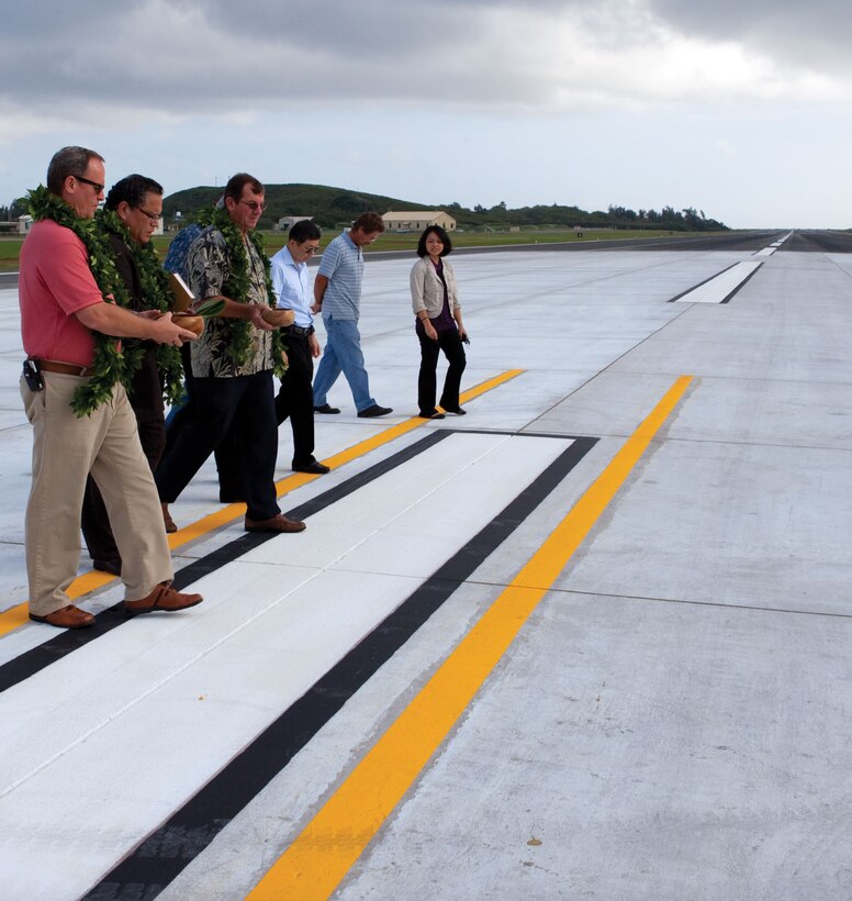 Pastor Kelekona Bishaw of Real Life Christian Center blesses the completed construction on Marine Corps Air Station Kaneohe Bay Feb. 15. The runway on Maj. Gen. Marion Eugene Carl Field reopened after two months of construction.