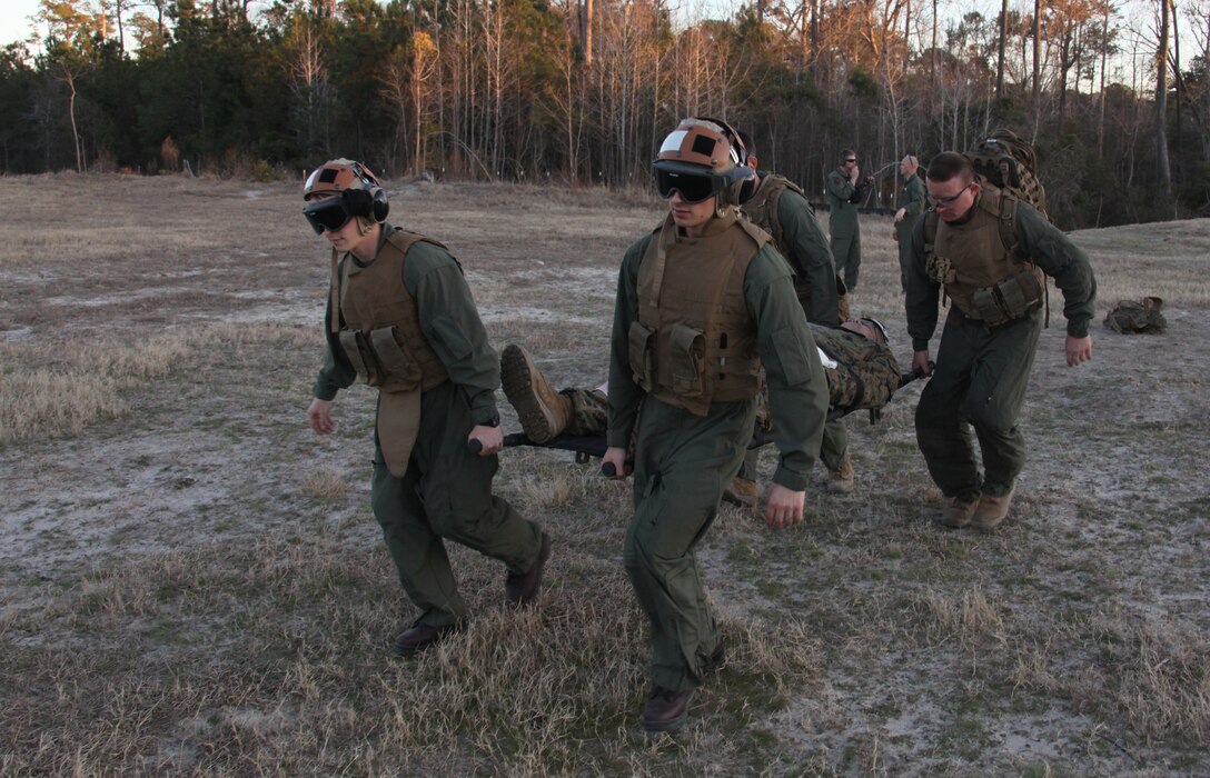 Corpsmen with the 22nd Marine Expeditionary Unit carry a patient to a MV-22B Osprey from the Marine Medium Tilt Rotor Squadron 263 (Reinforced), 22nd MEU, during tactical evacuation training at Stone Bay aboard Marine Corps Base Camp Lejeune, N.C., Feb. 15, 2011.  The corpsmen practiced treating patients while in flight during a two-week tactical evacuation course taught by the Special Operations Training Group, II Marine Expeditionary Force.  The Marines and sailors of the 22nd MEU are in the early stages of their pre-deployment training program, which is a series of progressively complex exercises designed to train and test the MEU's ability to operate as a cohesive and effective fighting force.