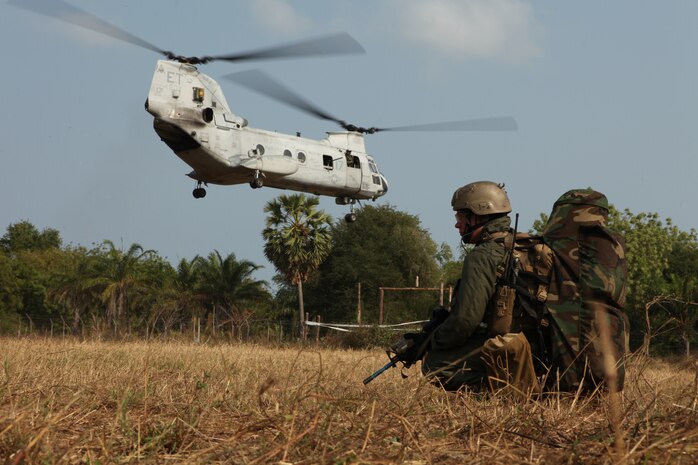 February 16, 2011, A U.S. Marine with the Maritime Raid Force, 31st Marine Expeditionary Unit, 3rd Marine Expeditionary Brigade, provides security as a U.S. Marine Corps CH-46E Sea Knight helicopter lands during a mock raid conducted with Royal Thai Marines in Hat Yao, Kingdom of Thailand, in support of Exercise Cobra Gold 2011. For three decades, Thailand has hosted Cobra Gold, one of the largest land-based, joint, combined military training exercises in the world.  A successful Cobra Gold 2011 results in increased operational readiness of U.S. and Thai forces and matured military to military relations between the two countries.