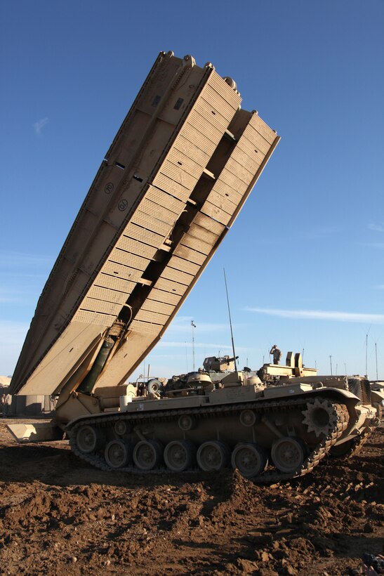 U.S. Marines with Company D, 1st Tank Battalion, assemble an Assault Vehicle Land Bridge (AVLB) at Combat Outpost Ouellette, Helmand province, Afghanistan, Feb. 16, 2011. The AVLB will allow Marines and tanks with Company D attached to Company I, Battalion Landing Team 3/8, 26th Marine Expeditionary Unit, Regimental Combat Team 8, to maneuver at will over various canals throughout their area of operation within Helmand province, Afghanistan. Elements of 26th Marine Expeditionary Unit deployed to Afghanistan to provide regional security in Helmand province in support of the International Security Assistance Force.