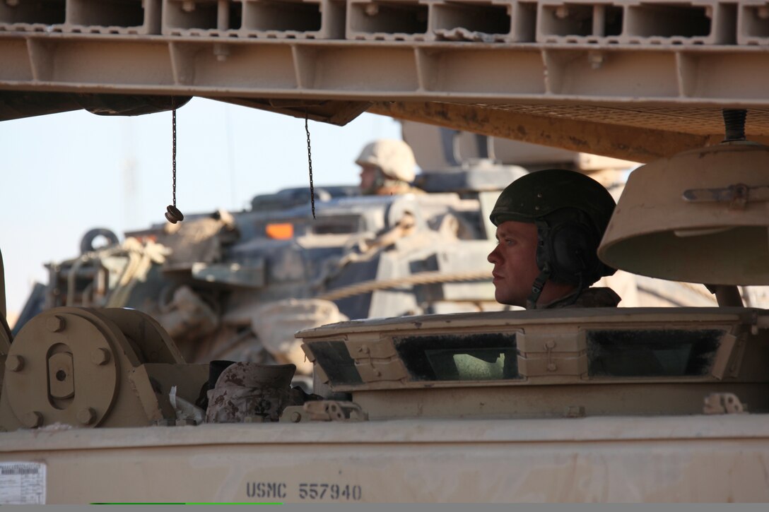 U.S. Marine Corps Lance Cpl. Jady Hubbard, a tank mechanic with Company D, 1st Tank Battalion, drives an Assault Vehicle Land Bridge (AVLB) at Combat Outpost Ouellette, Helmand province, Afghanistan, Feb. 16, 2011. The AVLB will allow Marines and tanks with Company D attached to Company I, Battalion Landing Team 3/8, 26th Marine Expeditionary Unit, Regimental Combat Team 8, to maneuver at will over various canals throughout their area of operation within Helmand province, Afghanistan. Elements of 26th Marine Expeditionary Unit deployed to Afghanistan to provide regional security in Helmand province in support of the International Security Assistance Force.