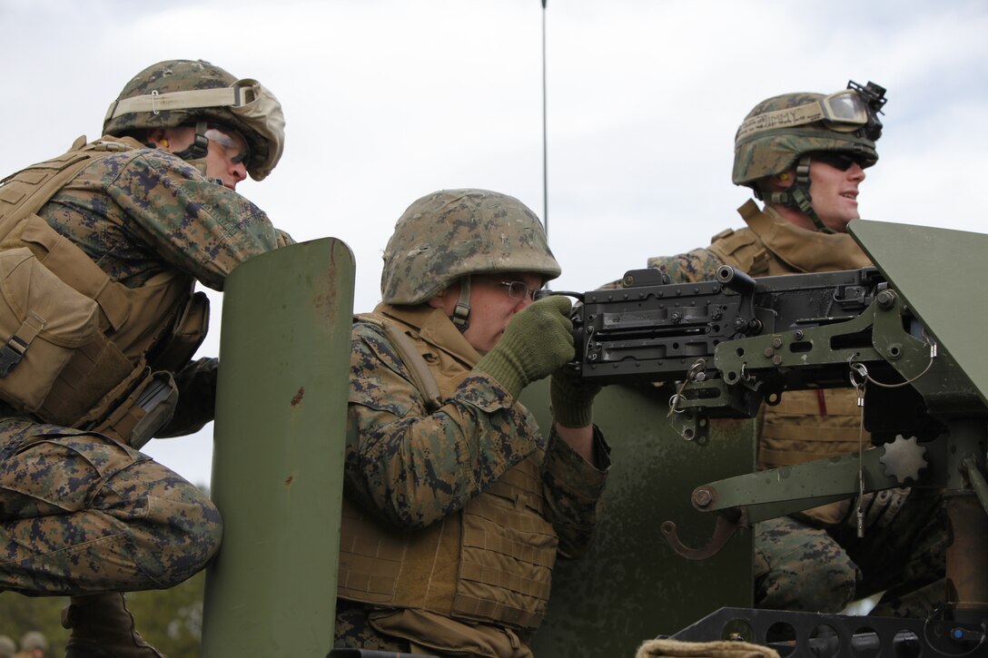 Cpl. Cameron S. Neivert, left, a gunner with Battery B, 2nd Low Altitude Air Defense Battalion, assists fellow gunner, Cpl. Michael J. Covey, in sighting down range at Marine Corps Base Camp Lejeune Feb. 16. The Battery B, 2nd LAAD, Marines engaged targets at nearly 600 yards from turrets atop humvees, tripods on the ground and from the standard prone position.