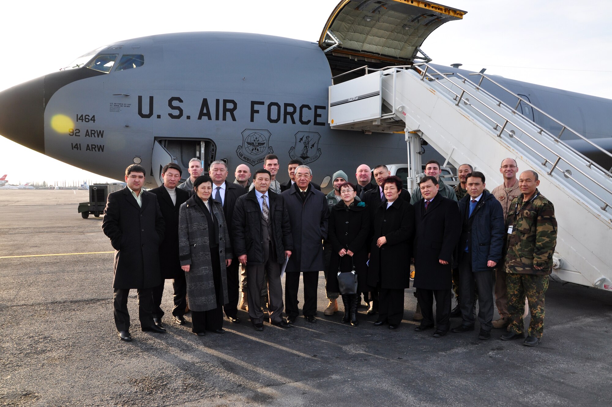 TRANSIT CENTER AT MANAS, Kyrgyzstan - Kyrgyz parliamentarians, Ministry of Defense and U.S. Air Force and Army personnel gather for a group photo after a first-ever flight for members of the Kyrgyz Parliment 16 Feb. After a reception and a briefing which detailed the mission and the significant financial impact of the Transit Center on the Kyrgyz economy, Parliament members were taken on a KC-135 Stratotanker for a demonstration refueling mission with a C-17 Globemaster III over the skies of Kyrgyzstan. This demonstration of air power highlighted to the parliamentarians the role of the Aerial Refuel mission here, one of the Transit Center's four mission pillars. The other three pillars which were highlighted in their pre-flight briefing are Onward Movement, Airlift and Humanitarian Assistance. (U.S. Air Force photo/Master
Sgt. Daniel Nathaniel)
