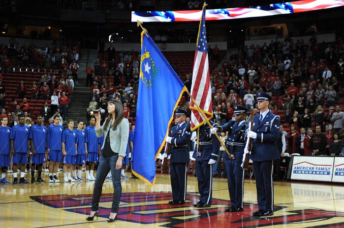 LAS VEGAS -- The Nellis Air Force Base Honor Guard presents the colors during the singing of the national anthem by Briana Rossi, before the U.S. Air Force Academy, University of Nevada Las Vegas basketball game, at the Thomas and Mack Center, Feb. 15. Rossi is a singer at the Cirque Du Soleil the "O" show. (U.S. Air Force photo by Airman 1st Class Daniel Hughes)