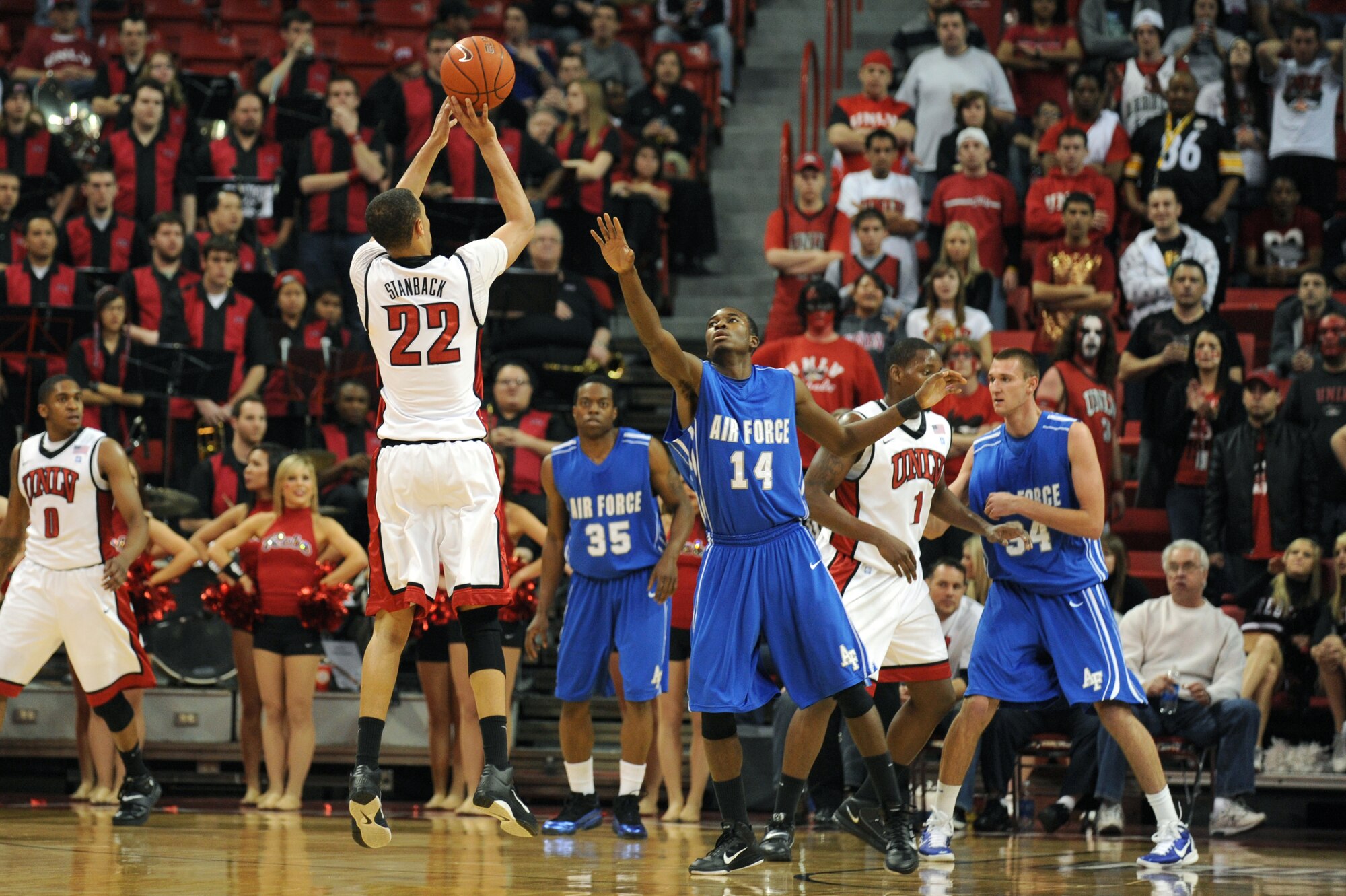 LAS VEGAS -- Chase Stanback, University of Nevada Las Vegas, junior guard, shoots a three point shot, as Micheal Lyons, U.S. Air Force Academy "Falcons" sophomore guard, plays defense at the Thomas and Mack Center, Feb. 15. The Air Force Falcons came up short against  UNLV 49-42, making their record 13-11 overall and 4-7 in the Mountain West Conference. (U.S. Air Force photo by Airman 1st Class Daniel Hughes)